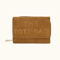 Brown suede tote bag with 'THE TOTE BAG' embossed on it against a white background