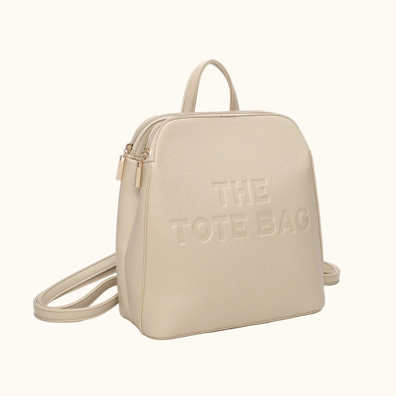 Beige backpack with 'THE TOTE BAG' text on a white background