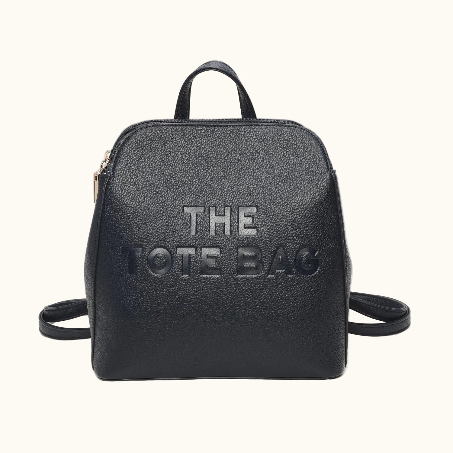 Black backpack with 'THE TOTE BAG' text on a white background