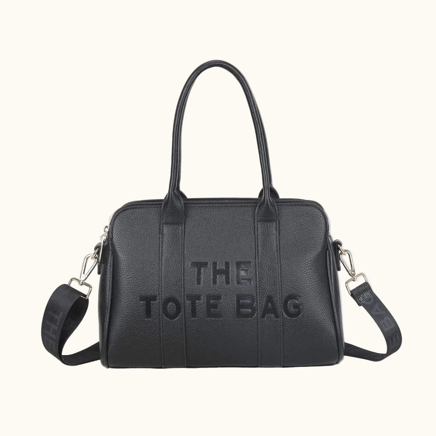 Black tote bag with 'THE TOTE BAG' text on a white background