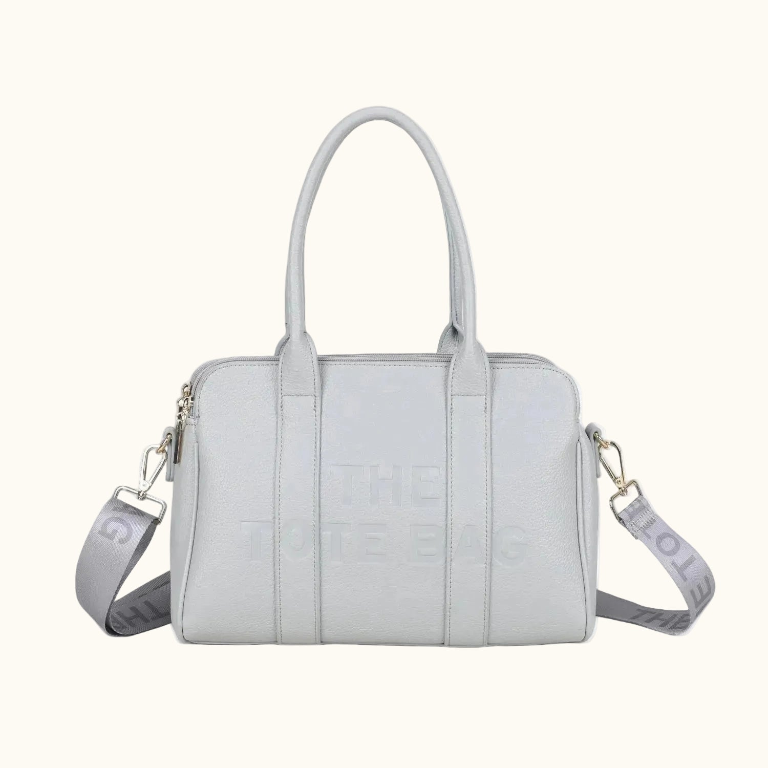 Light gray handbag with a shoulder strap on a white background