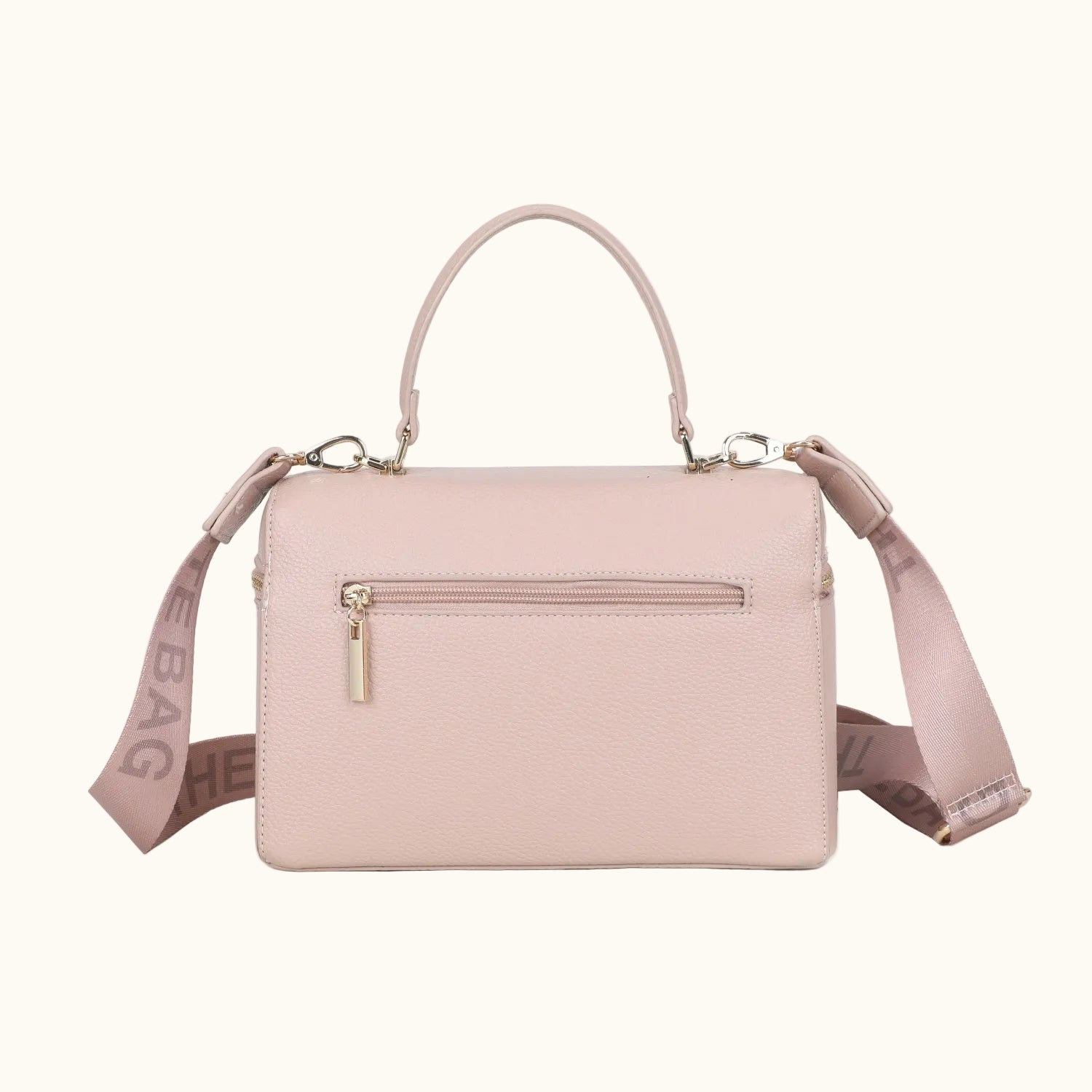 Pink handbag with a strap on a white background
