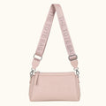 Pink handbag with matching strap on a white background