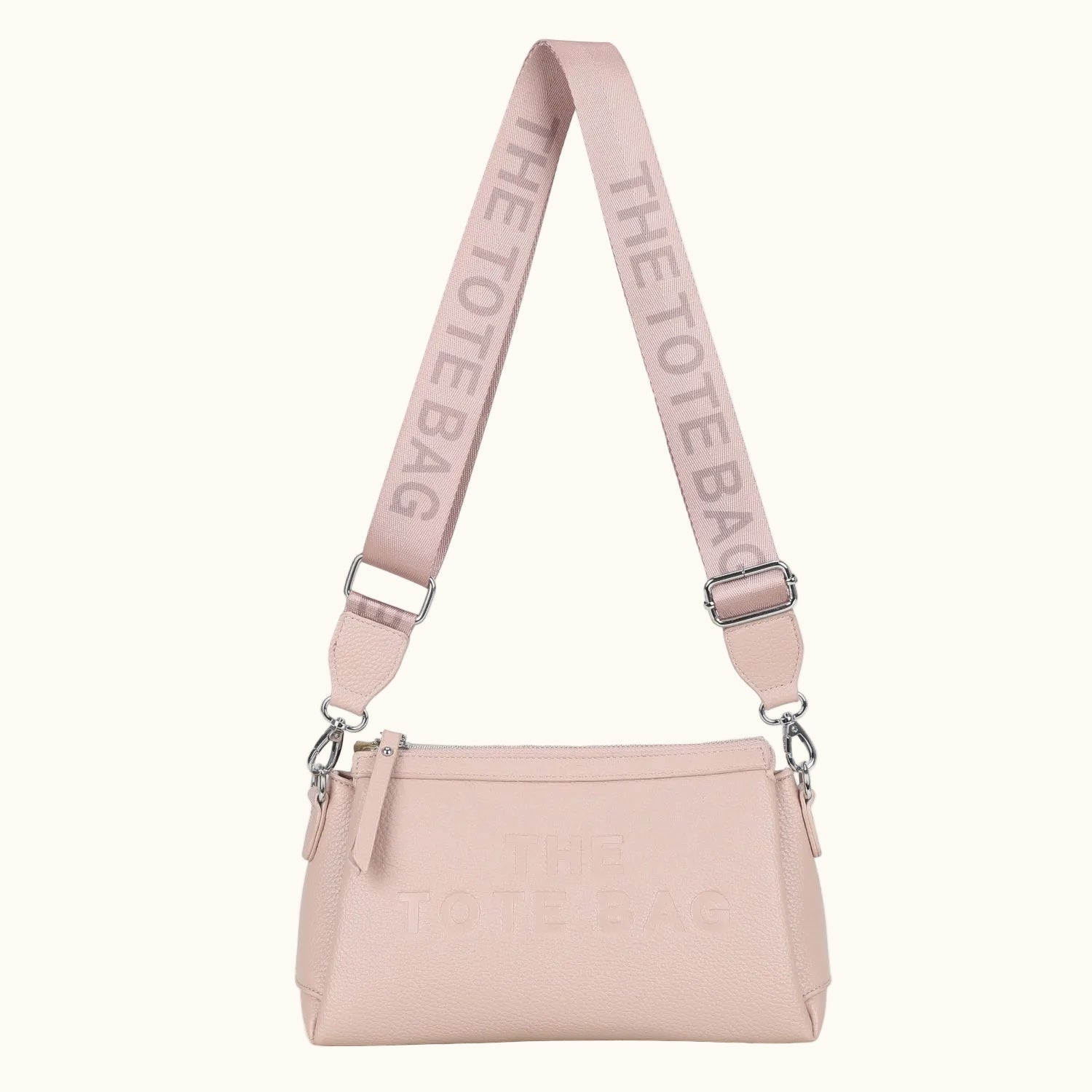 Pink handbag with matching strap on a white background
