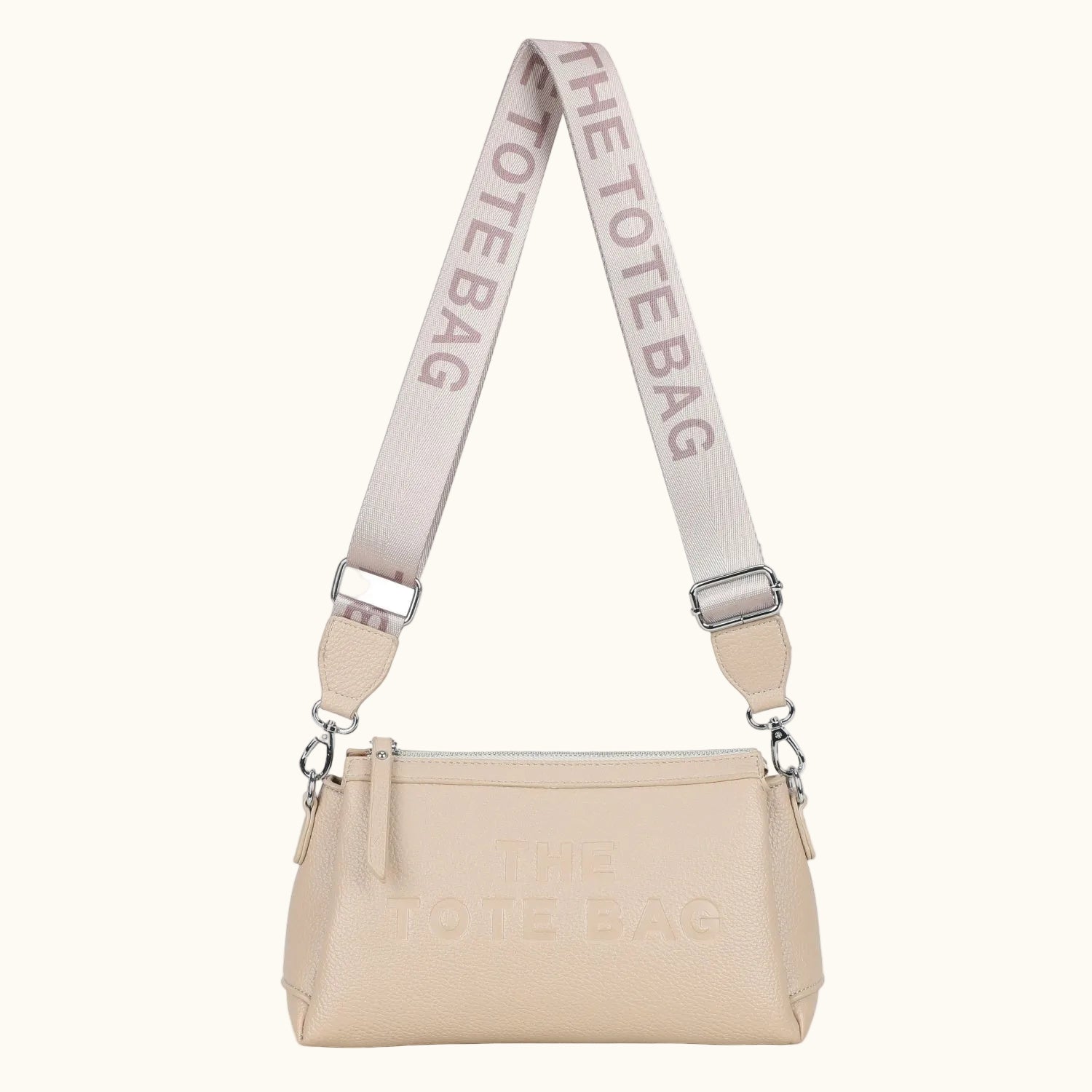 Beige handbag with a strap labeled 'The Tote Bag' on a white background