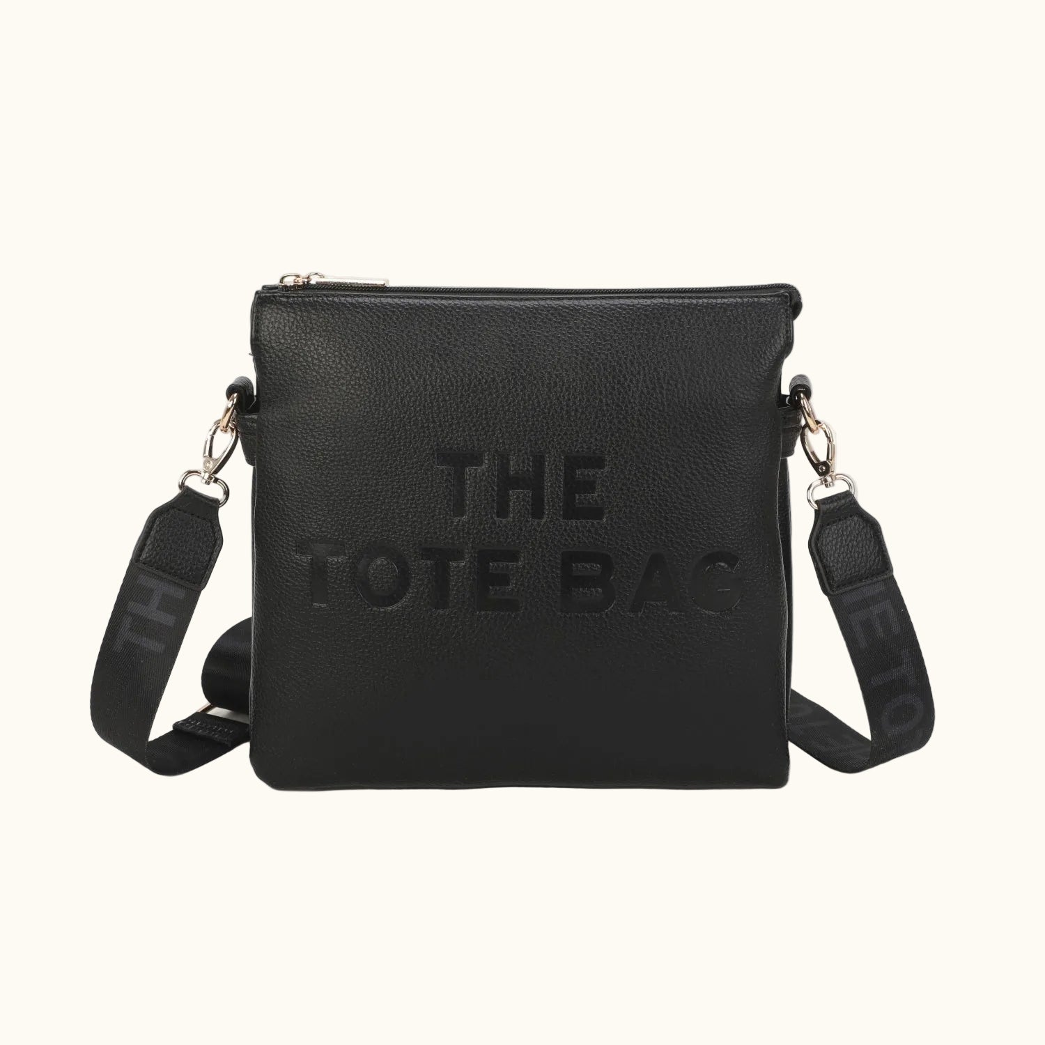 Black tote bag with 'THE TOTE BAG' embossed text on a white background