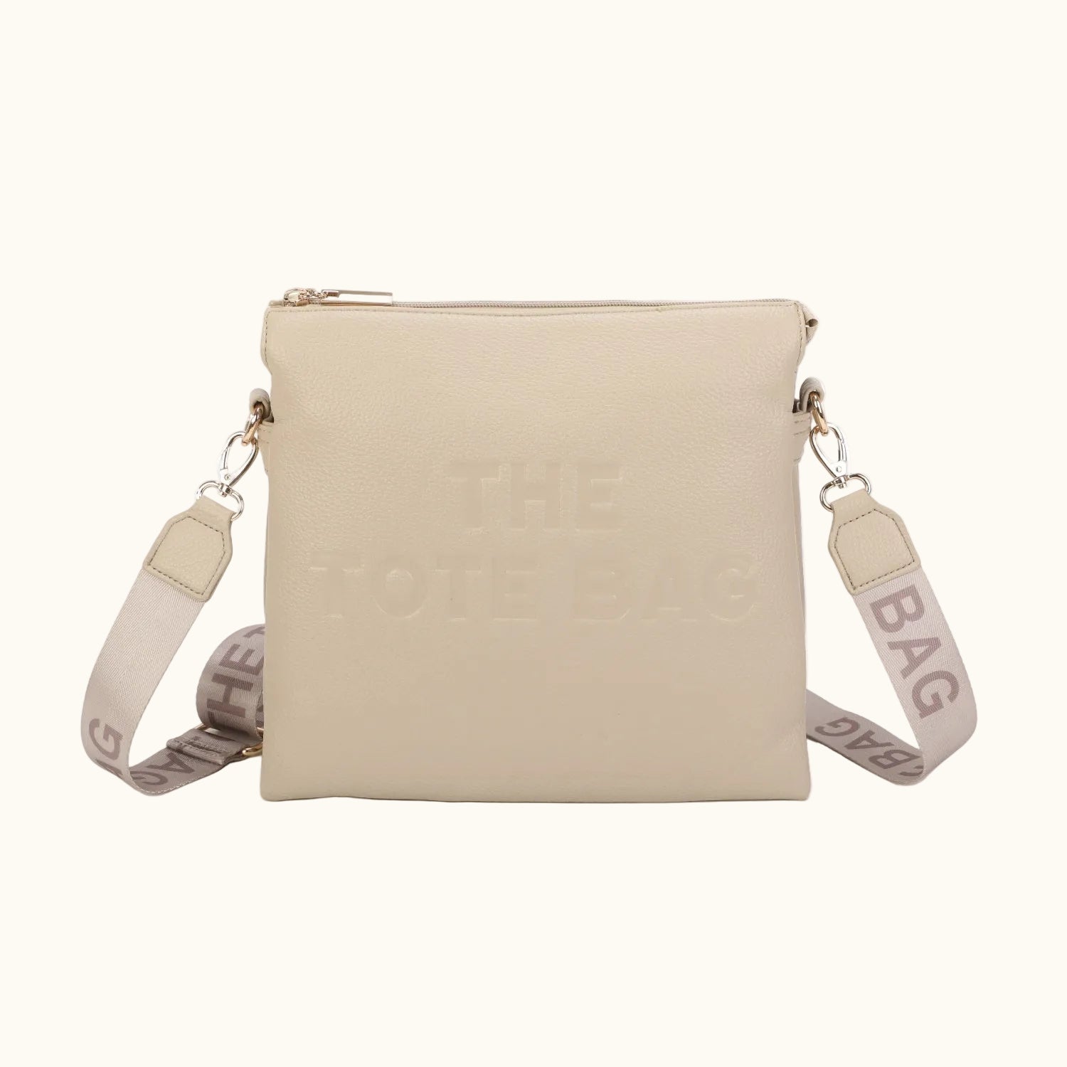 Beige crossbody bag with a strap on a white background