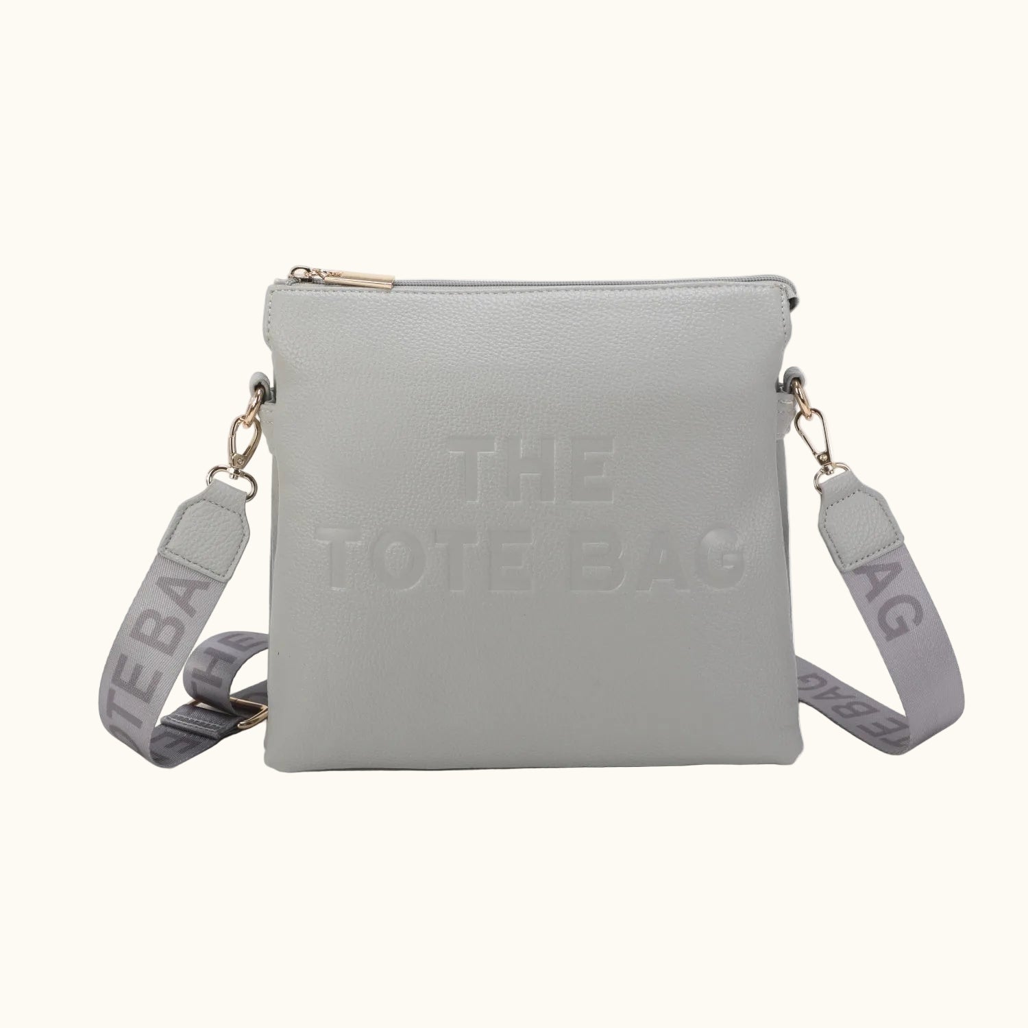 Gray tote bag with 'The Tote Bag' text on a white background
