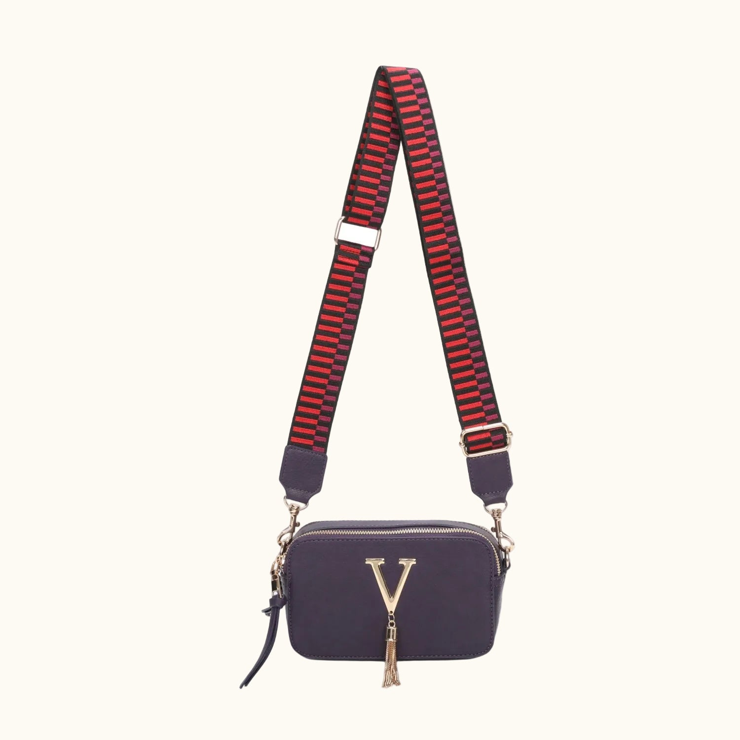 Navy handbag with a red and black striped strap on a white background