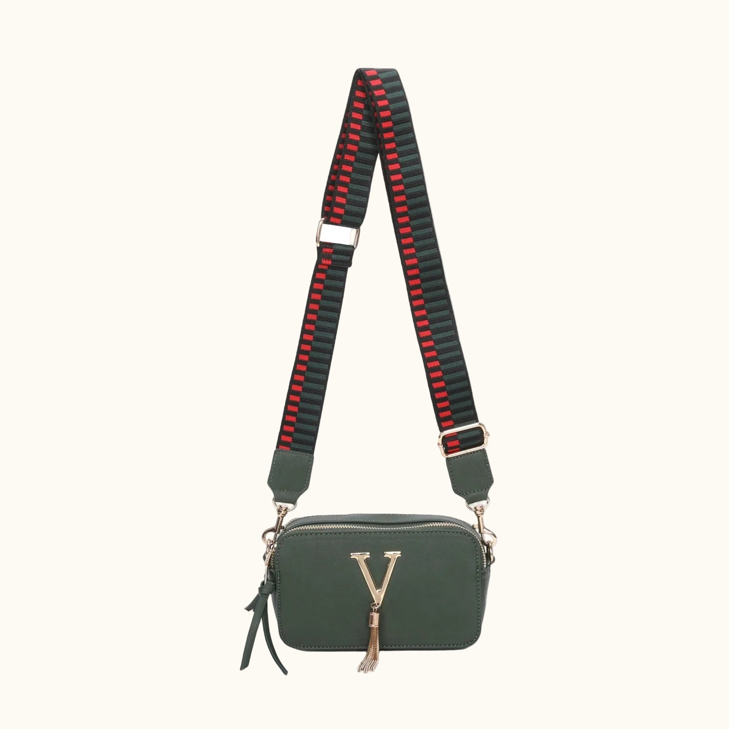 Green handbag with a black and red striped strap on a white background