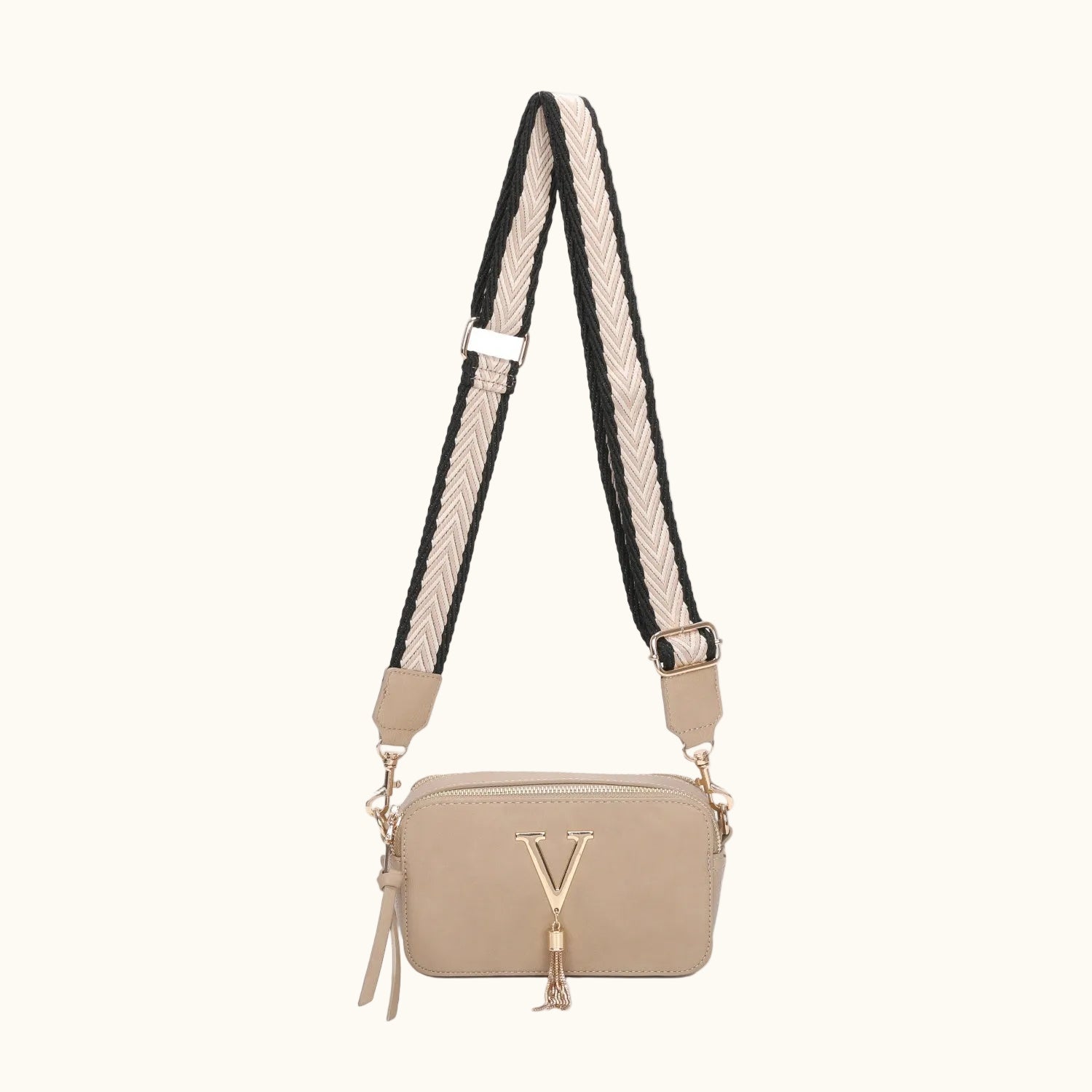 Pink crossbody bag with a tassel on a white background