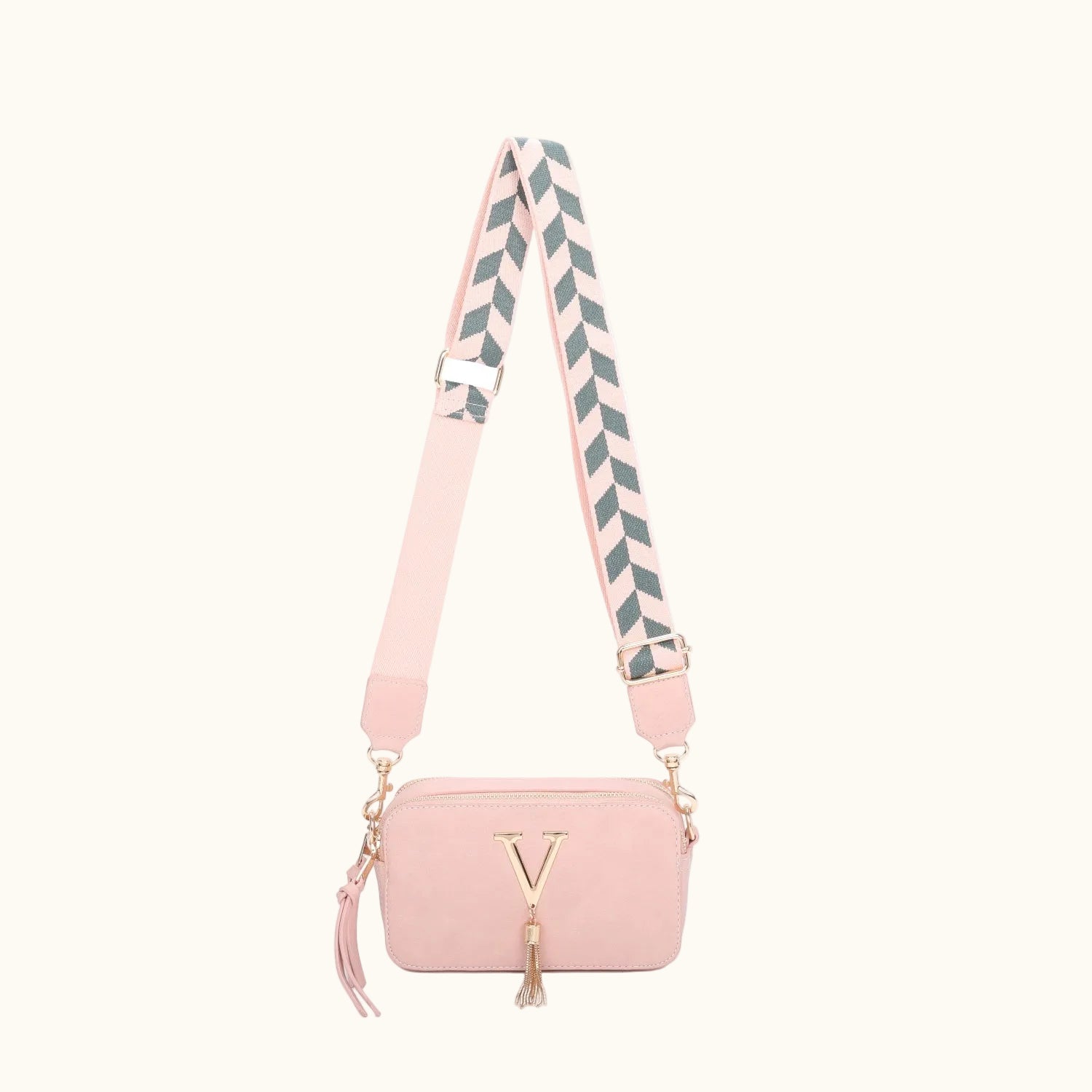 Pink handbag with a striped strap on a white background