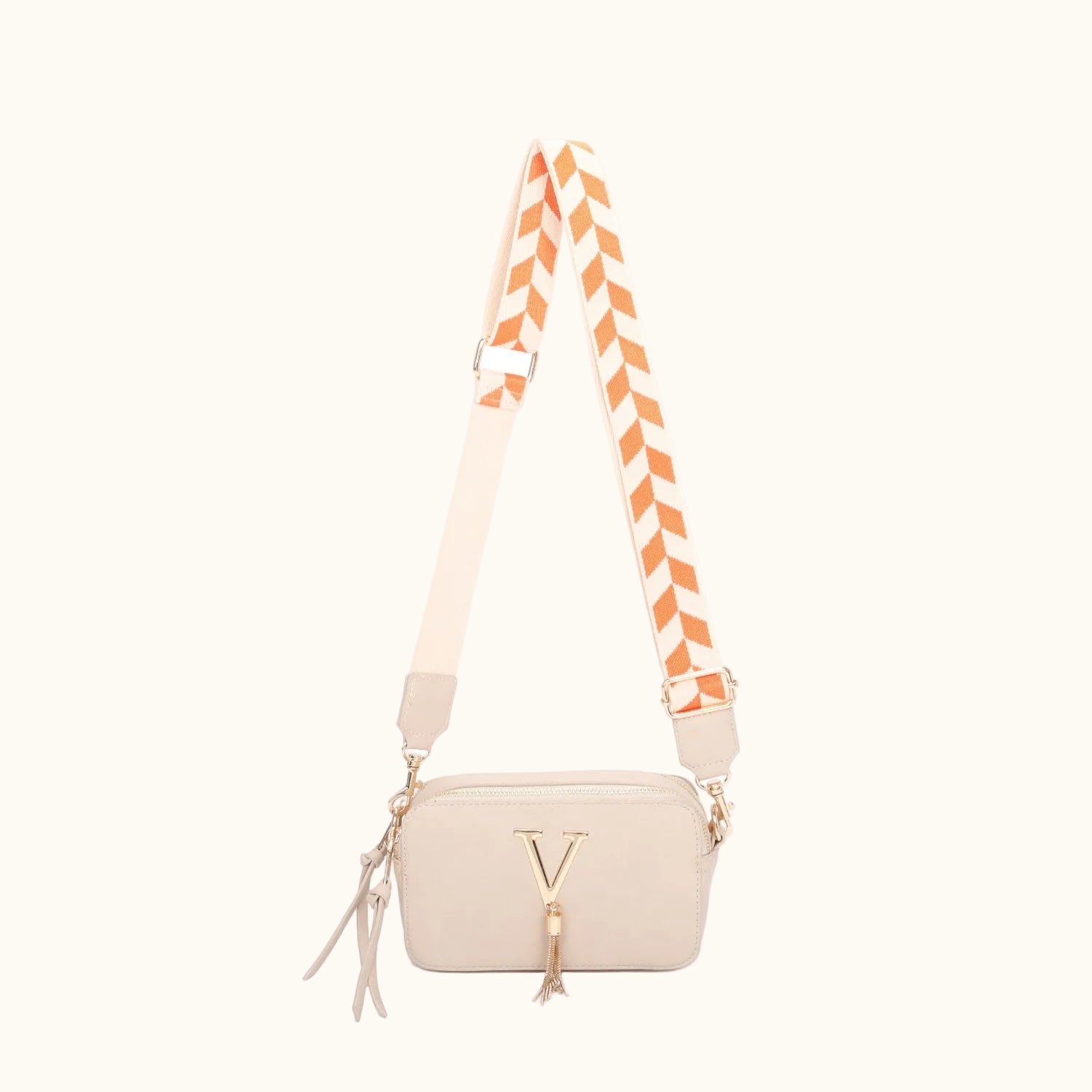 Beige handbag with a striped strap on a white background