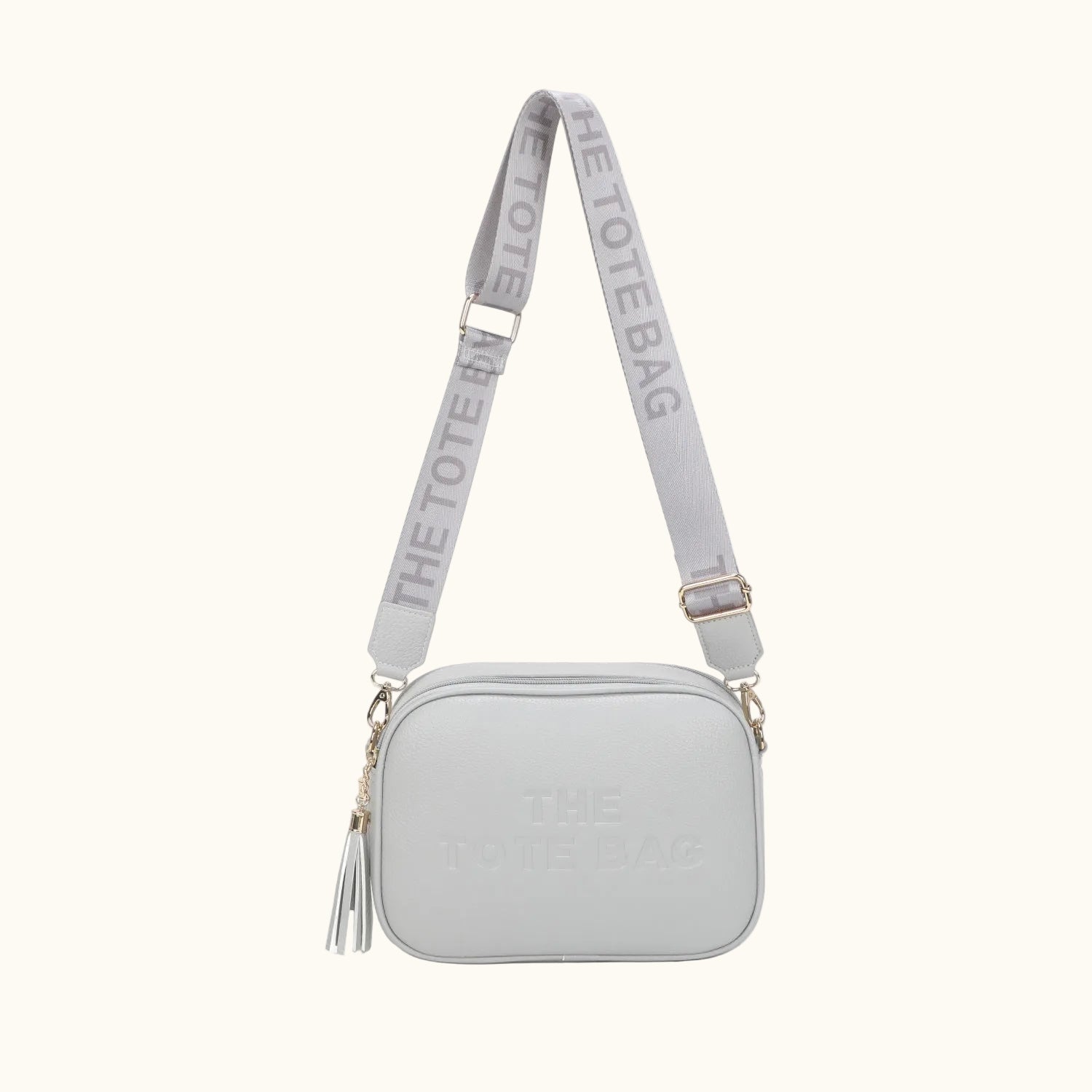 Light gray crossbody bag with matching strap on a white background