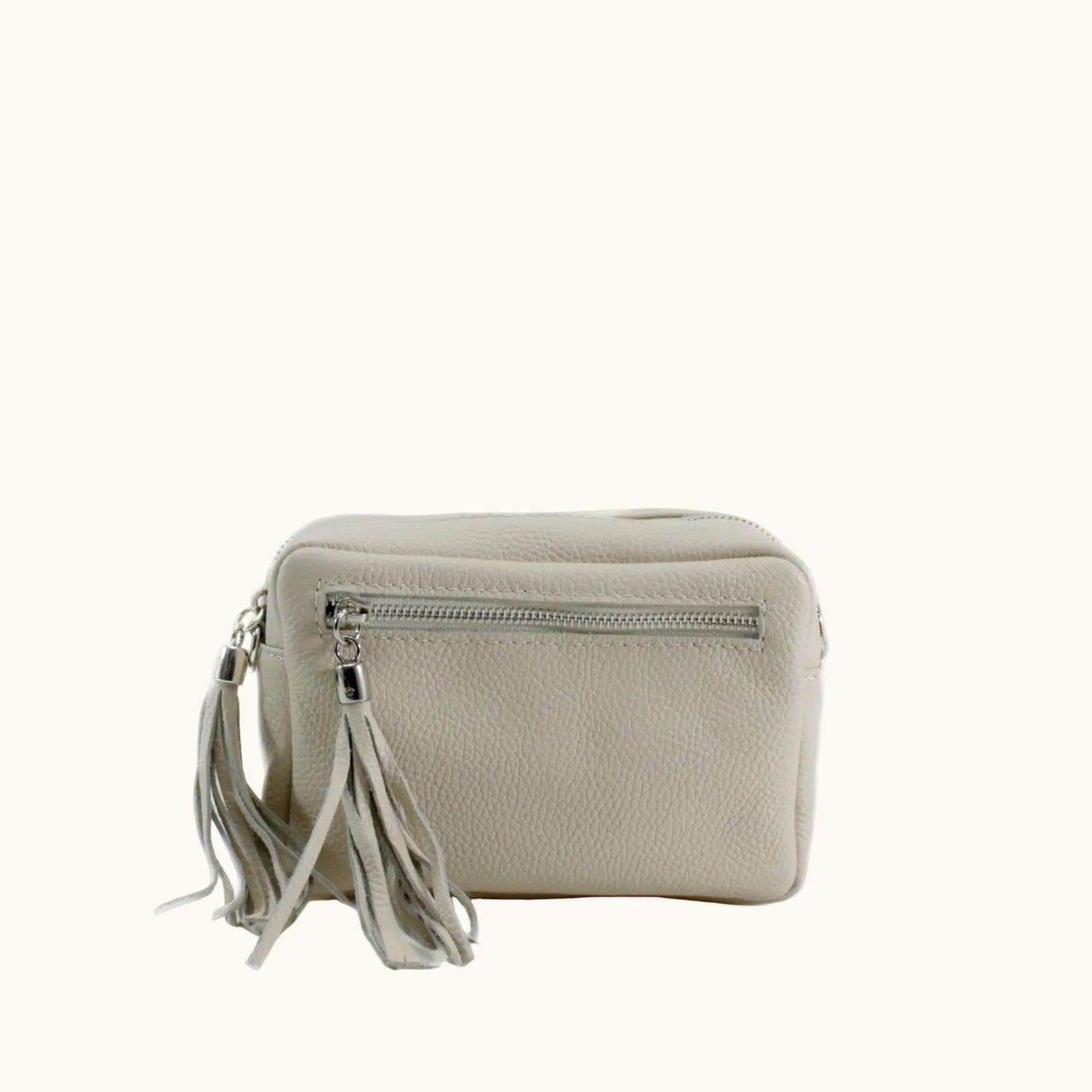 Beige crossbody bag with tassels on a white background