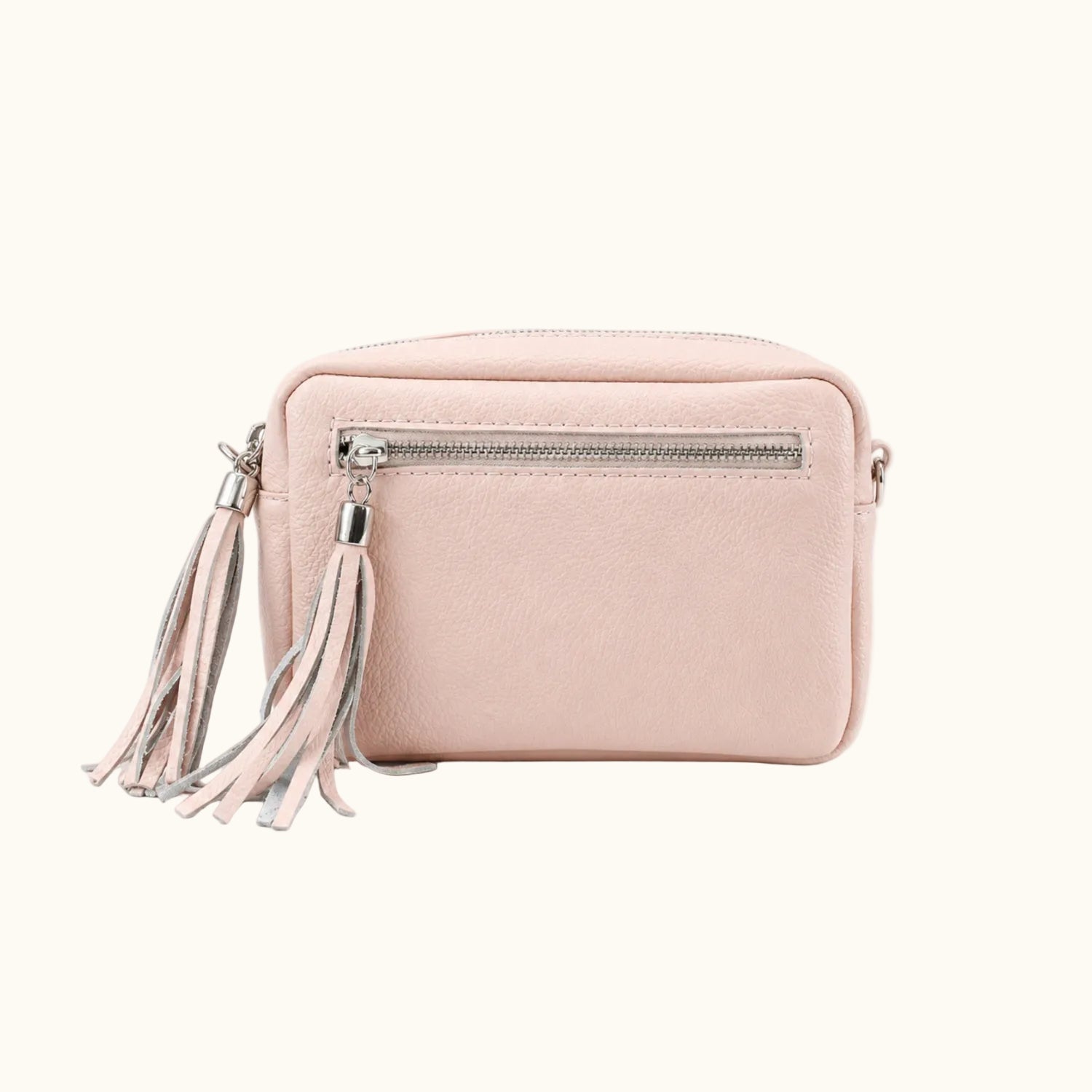 Pink crossbody bag with tassel on a white background