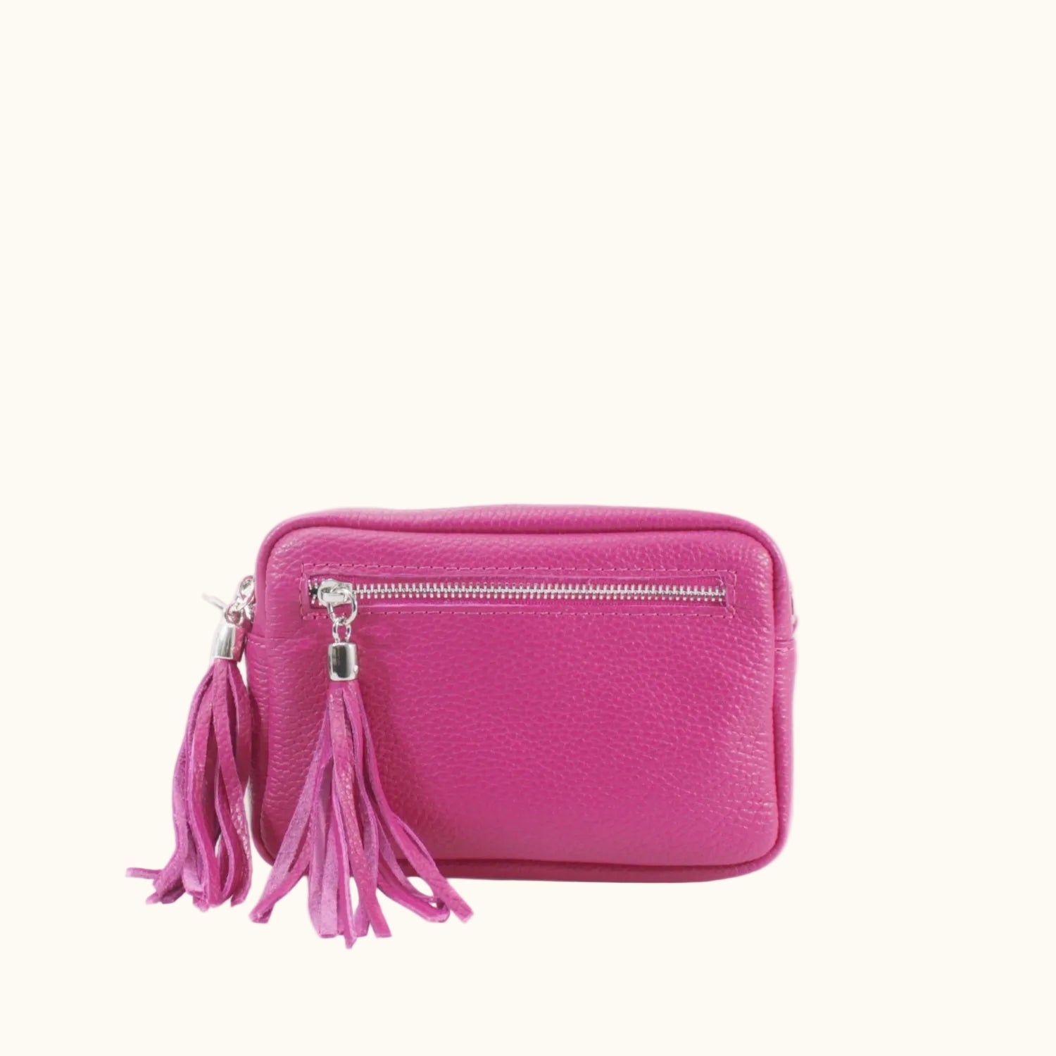 Pink purse with a tassel on a white background