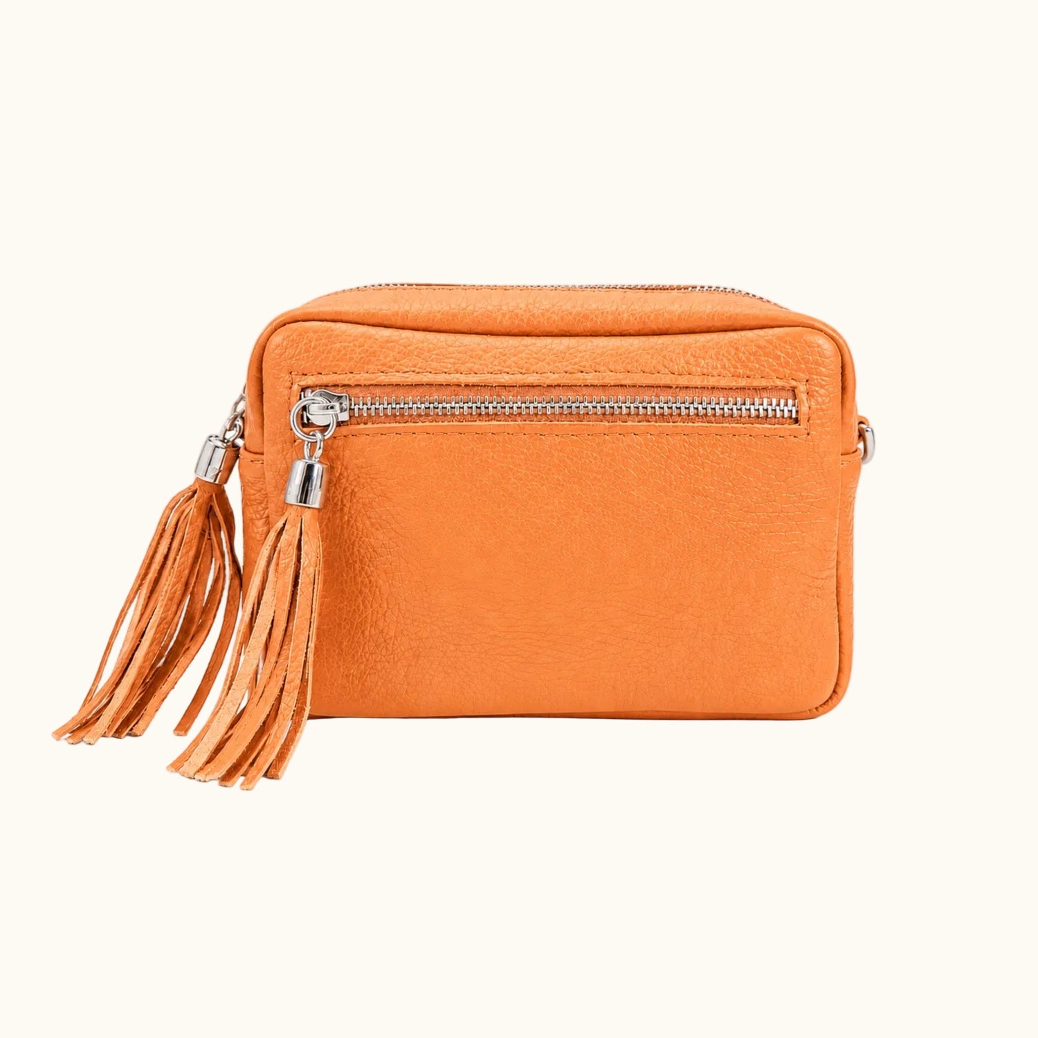Orange crossbody bag with a tassel on a white background