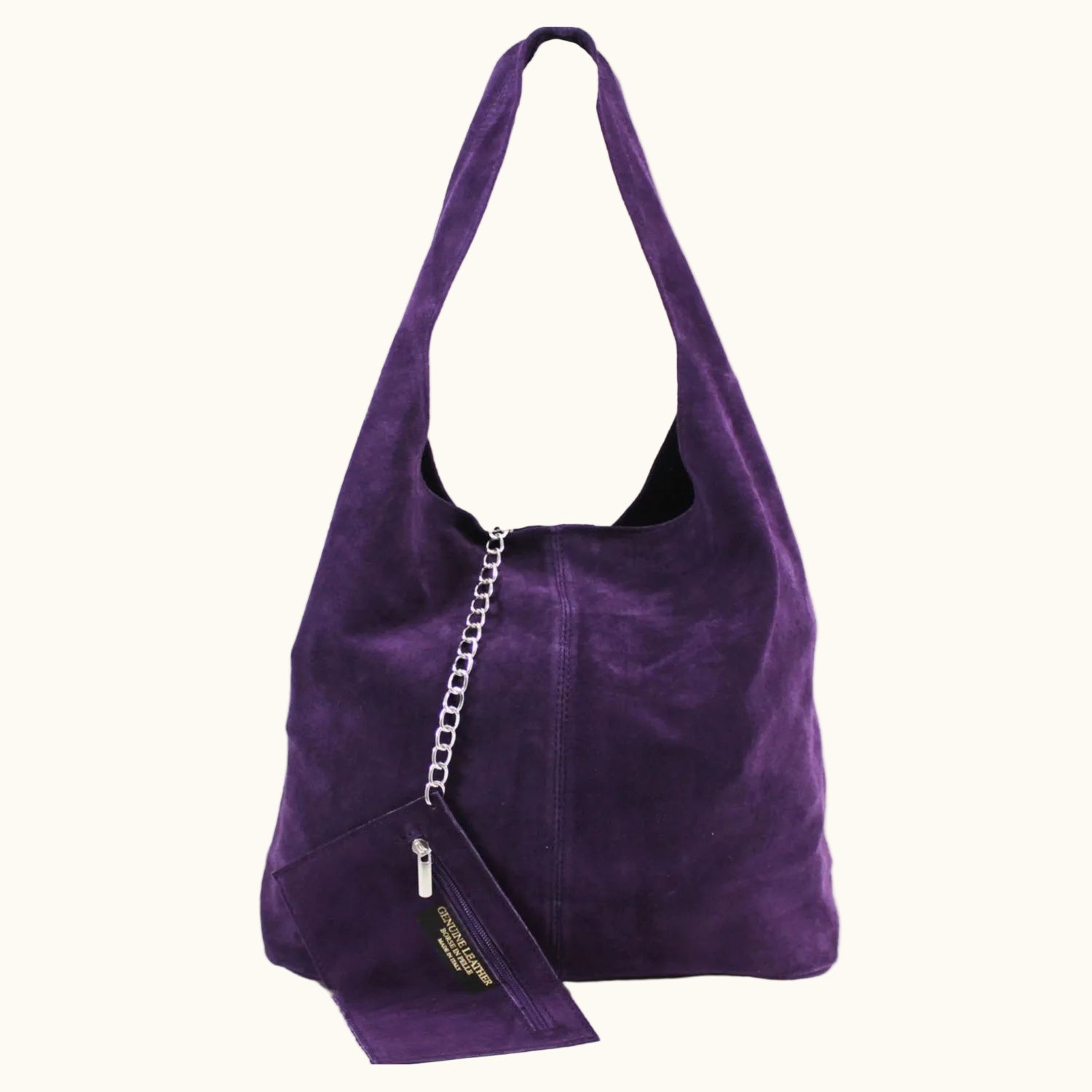 Purple suede handbag with a chain detail on a white background
