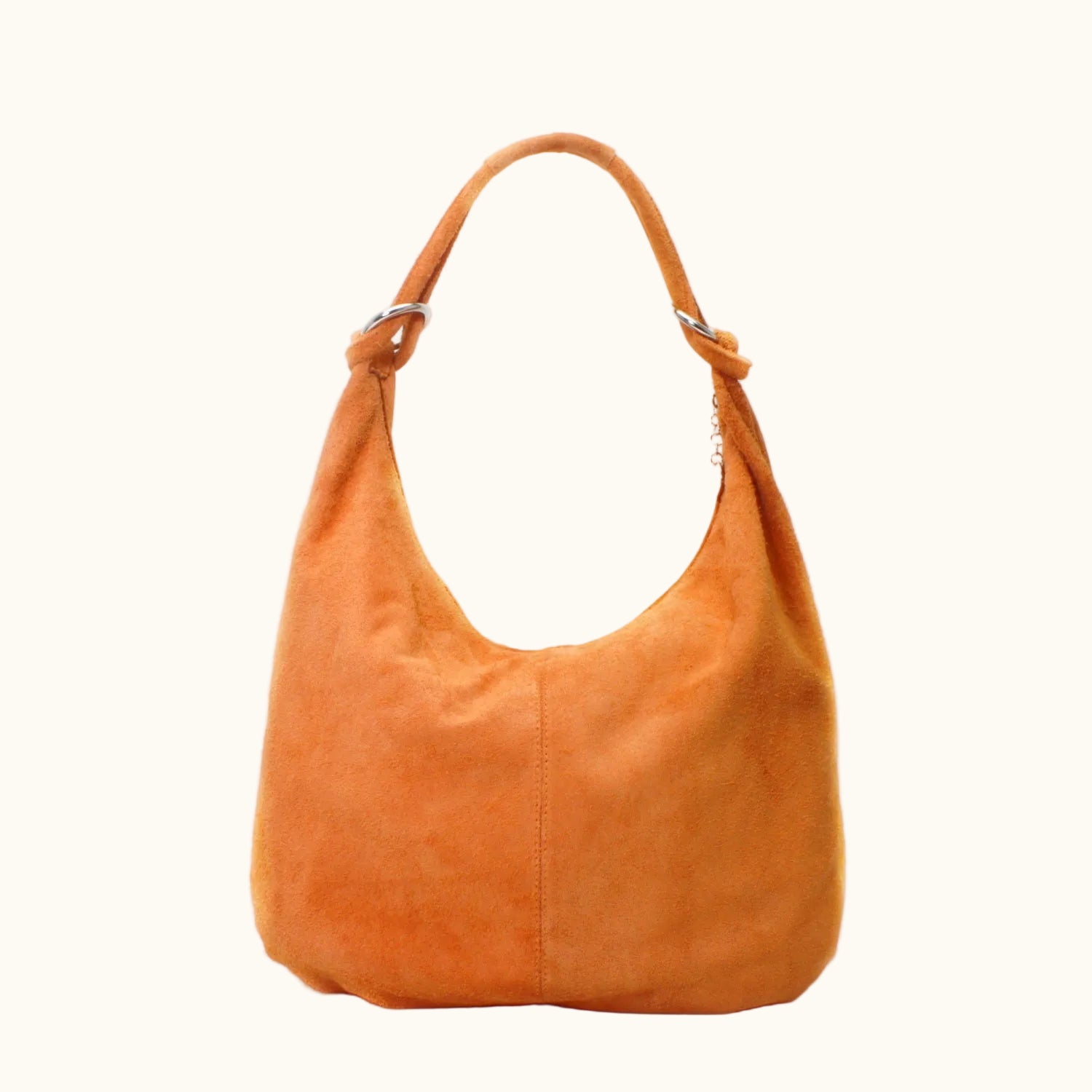 Orange suede handbag on a white background