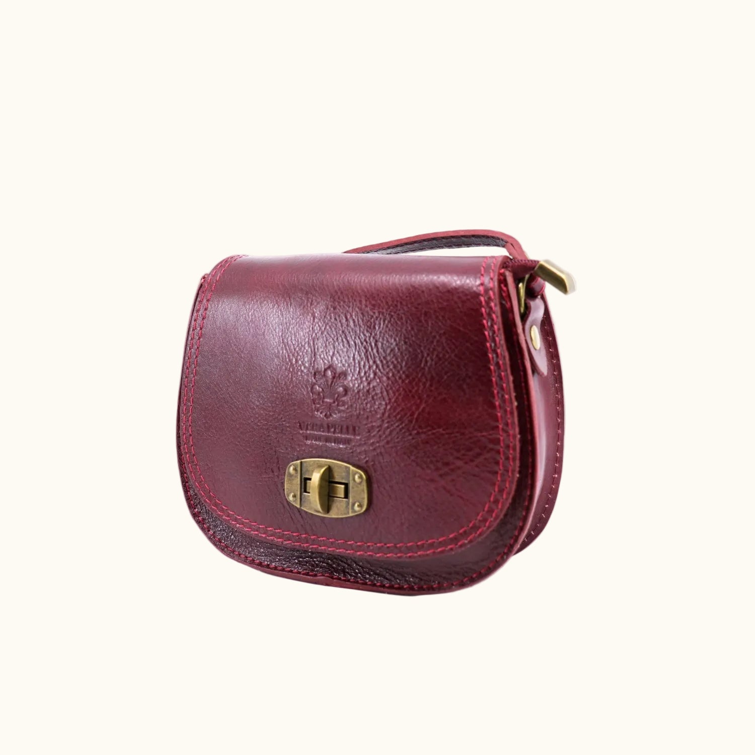 Red leather purse with gold clasp on a white background
