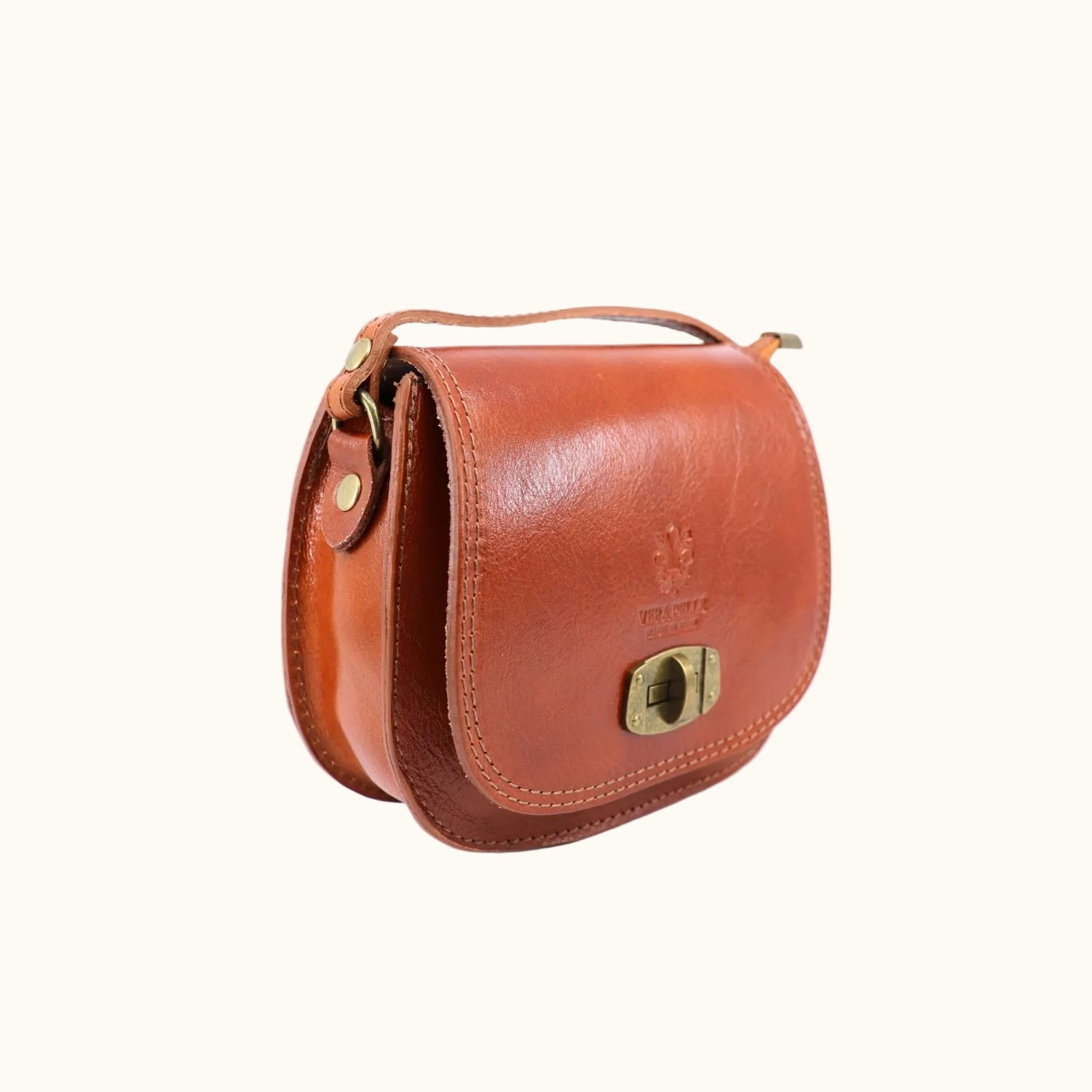 Brown leather handbag with gold accents on a white background