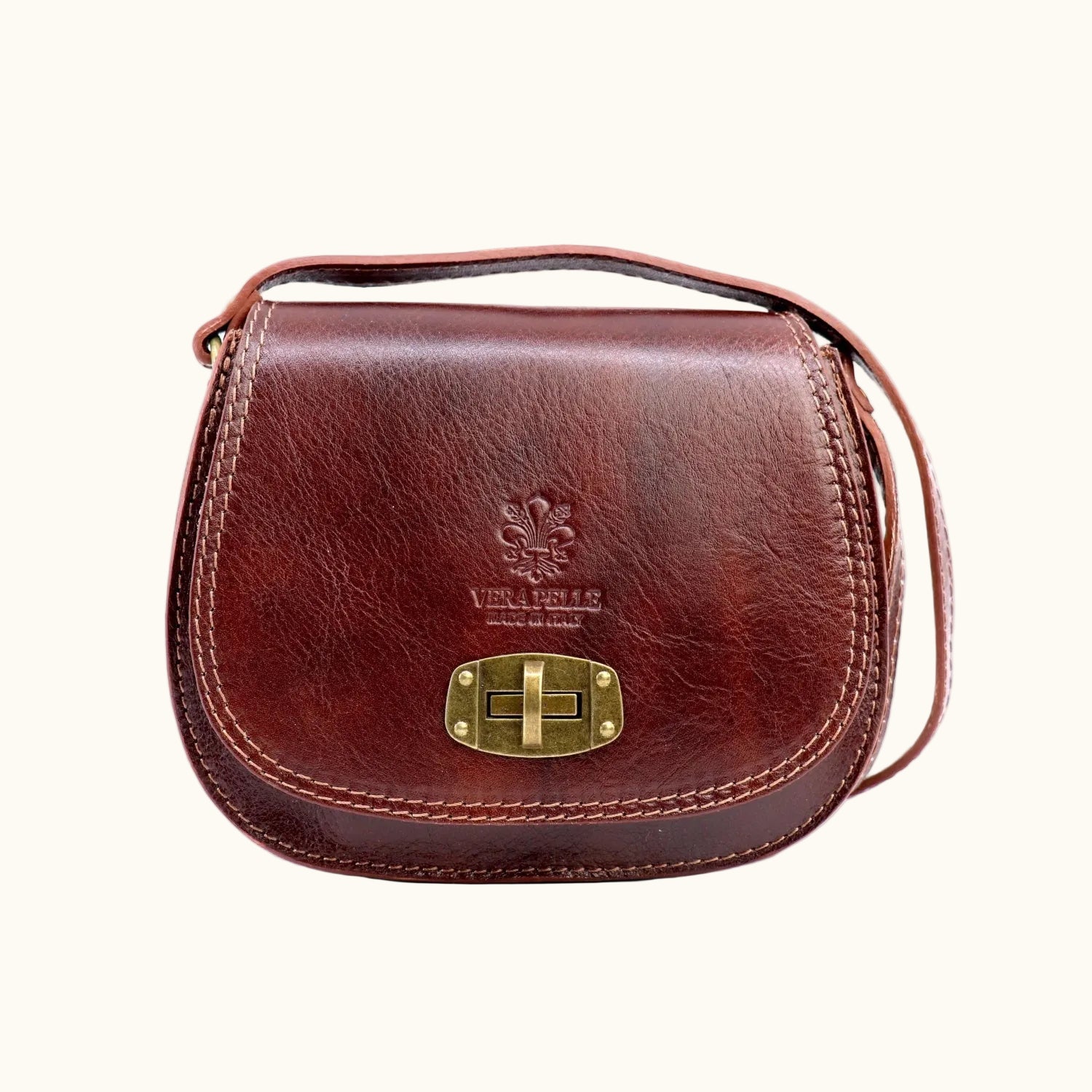 Brown leather handbag with gold clasp on a white background