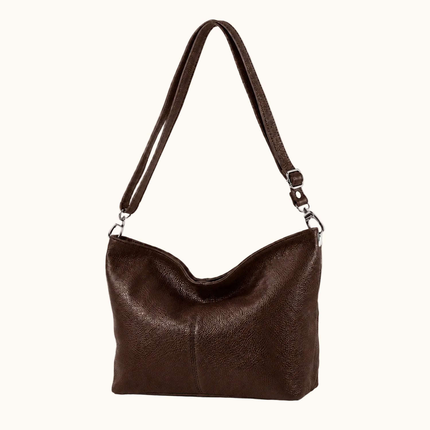 Brown leather handbag with a shoulder strap on a white background