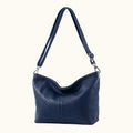 Black leather handbag with a shoulder strap on a white background