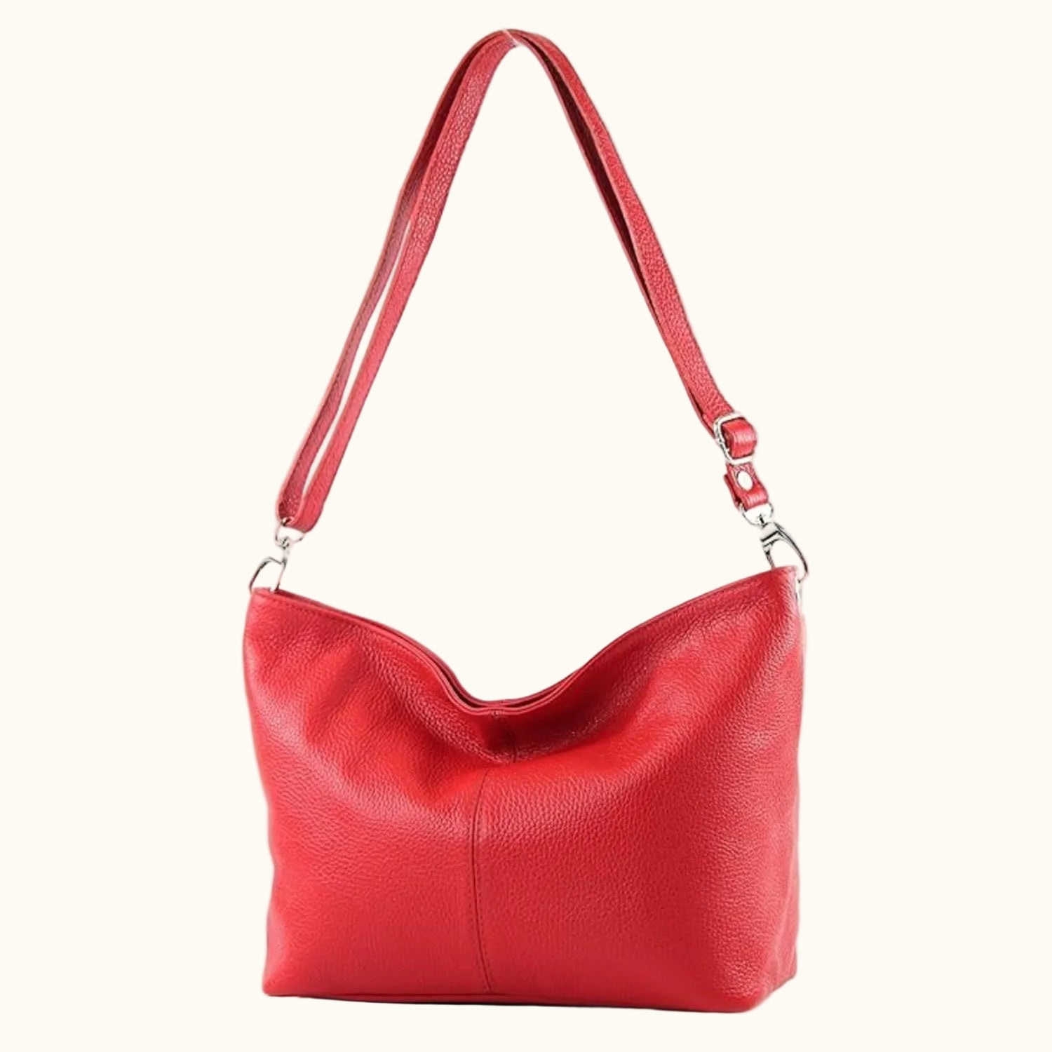 Red handbag with a strap on a white background
