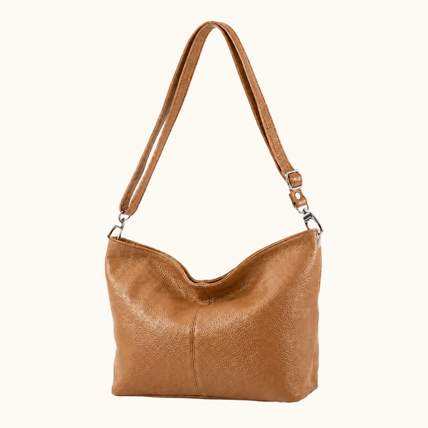 Brown leather handbag with a strap on a white background