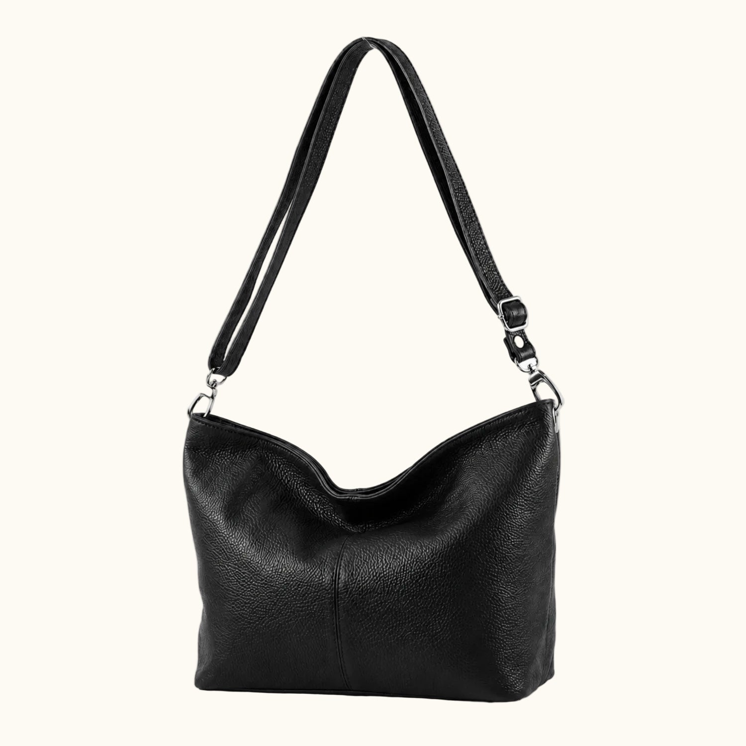 Black leather handbag with a shoulder strap on a white background