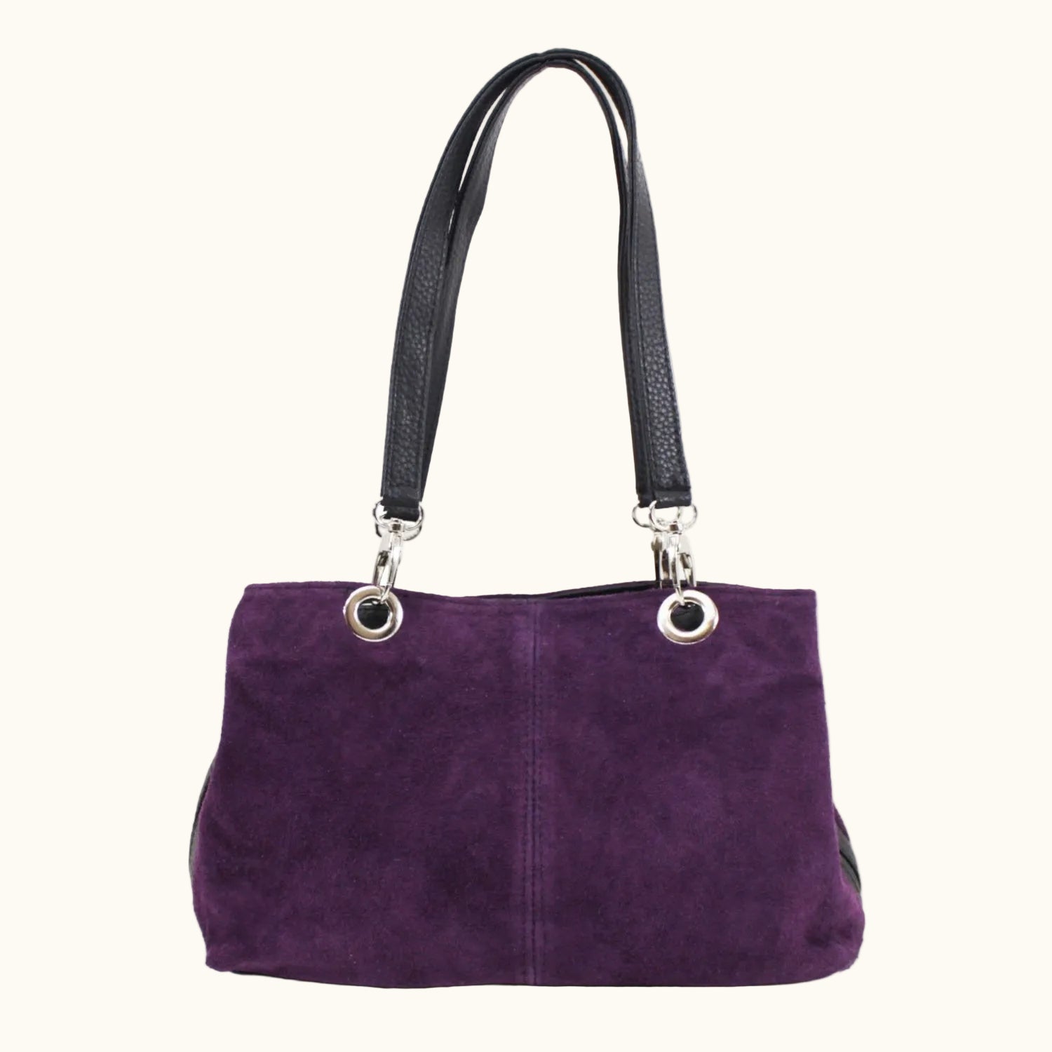Purple handbag with black handle on a white background