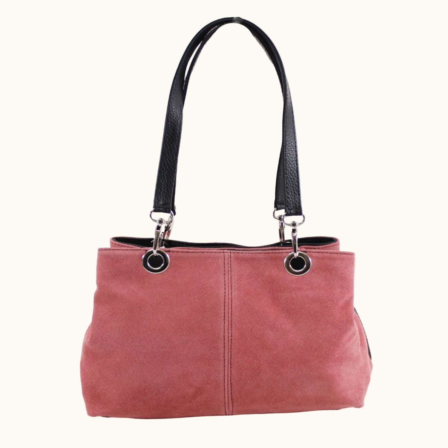 Pink handbag with black handle and trim on a white background