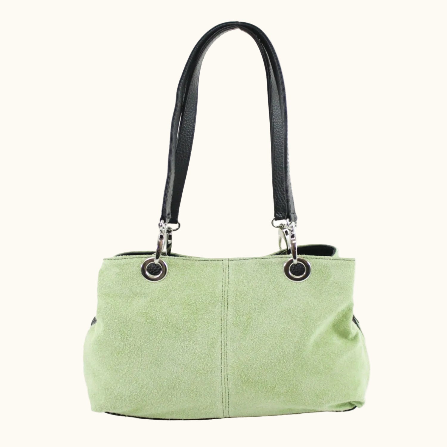 Green handbag with black handle on a white background