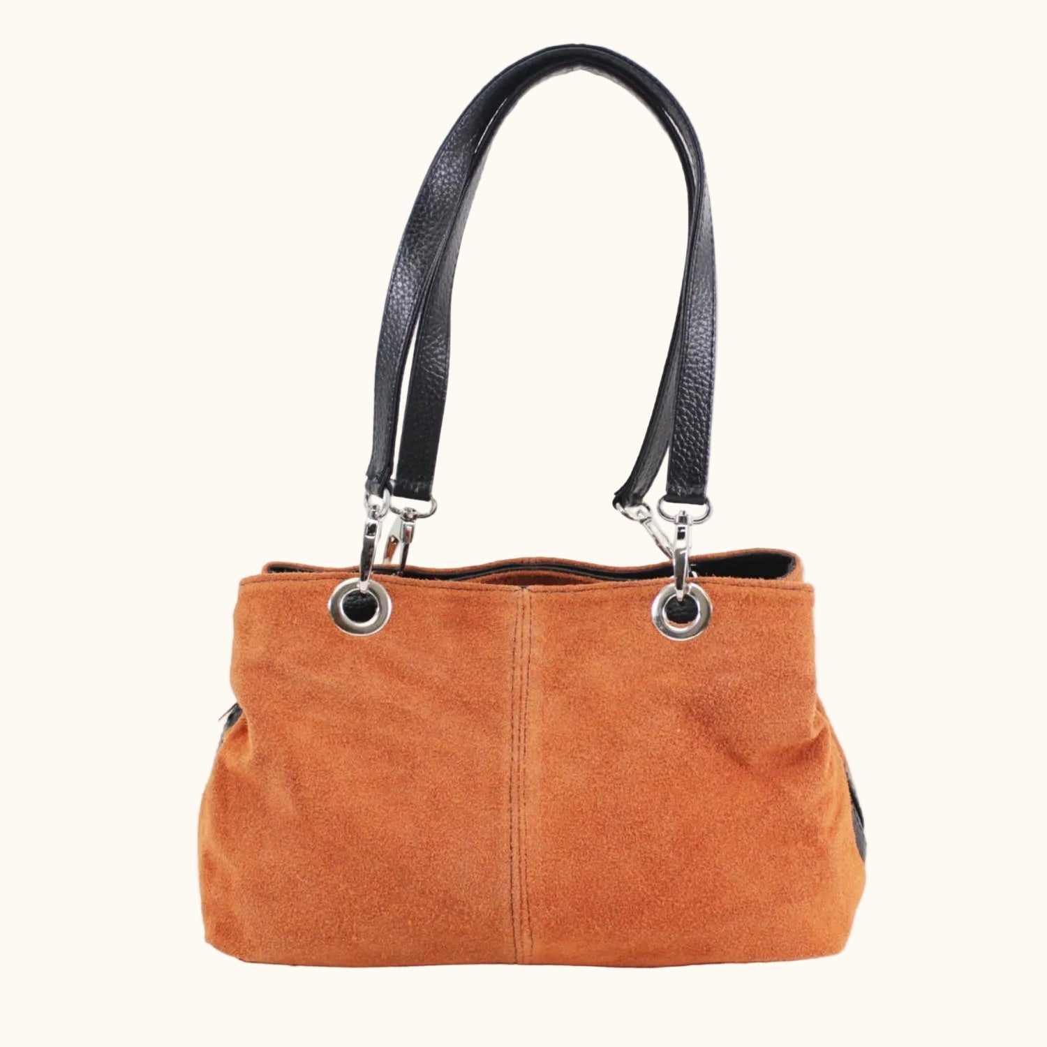 Brown handbag with black handle on a white background