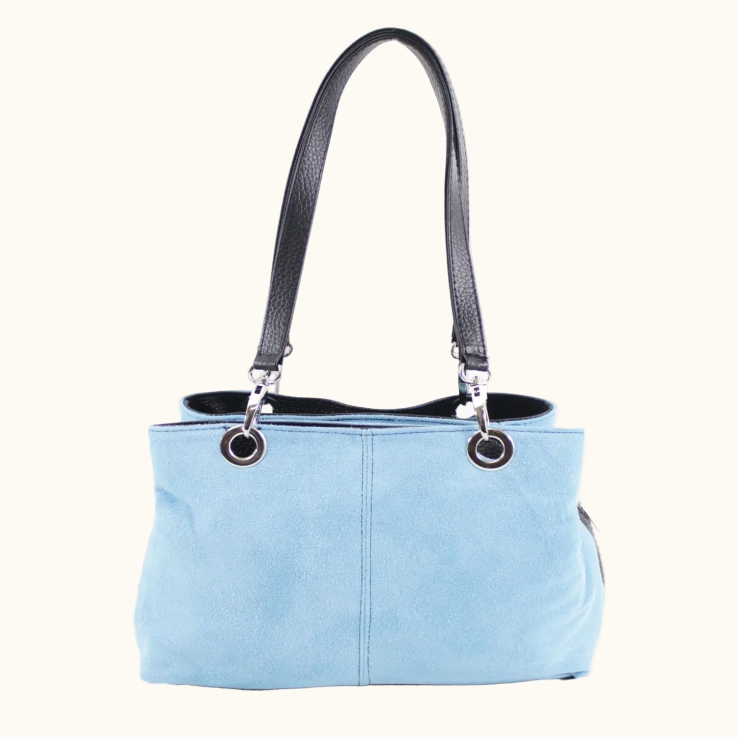 Light blue handbag with black handle on a white background
