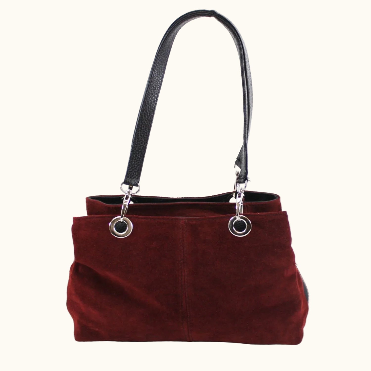 Red handbag with black handle on a white background