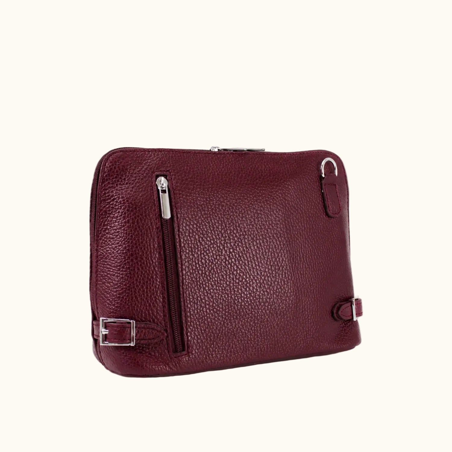 Burgundy leather bag with silver zippers on a white background