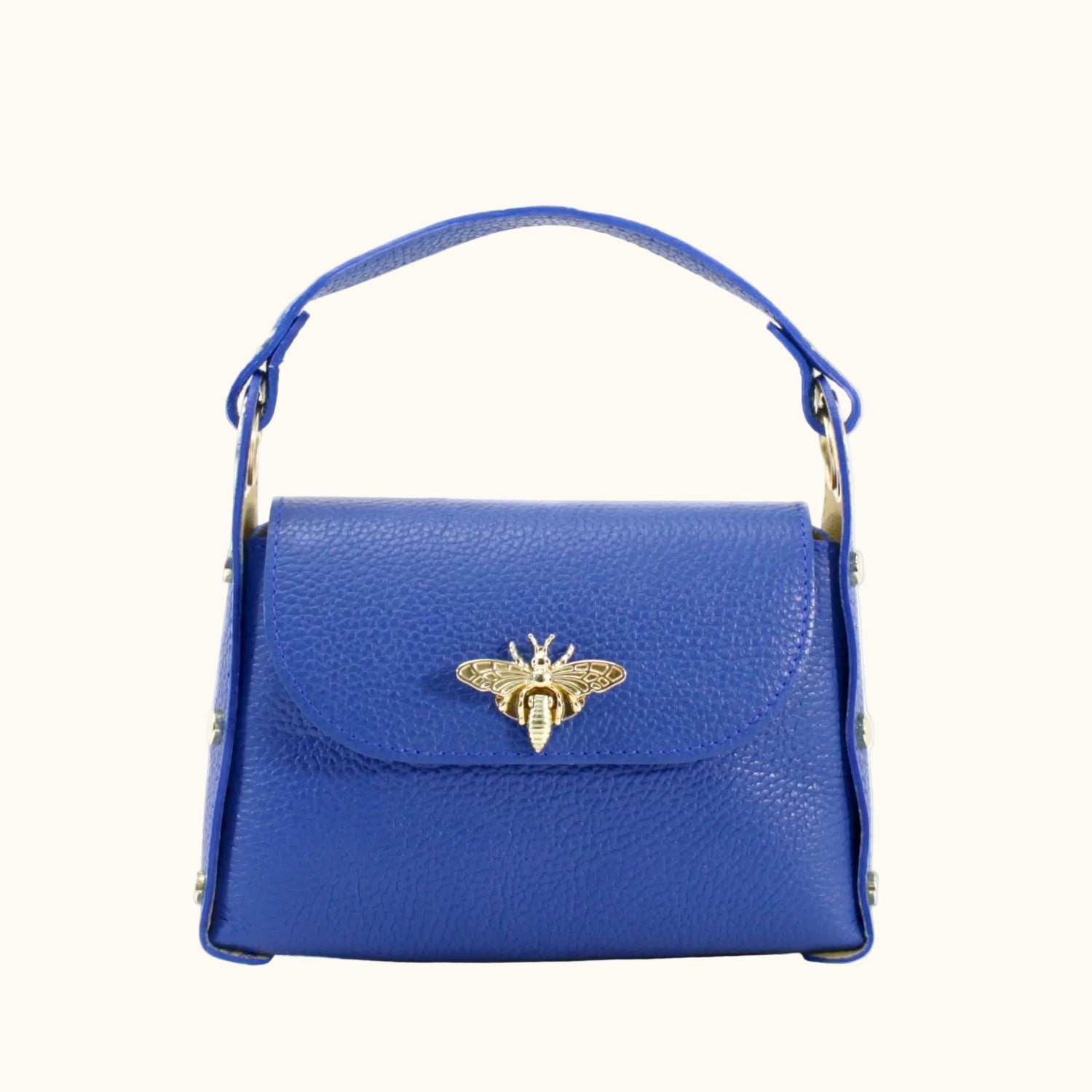 Blue handbag with a gold bee emblem on a white background