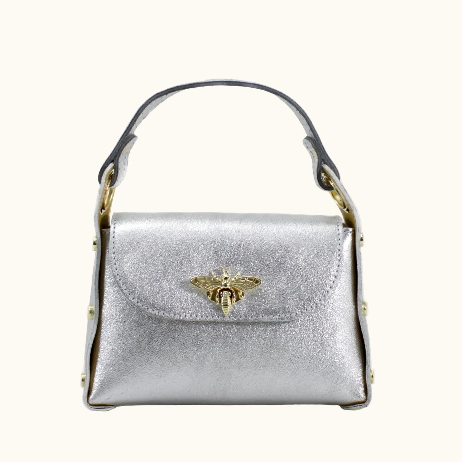 Silver handbag with a gold bee emblem on a white background