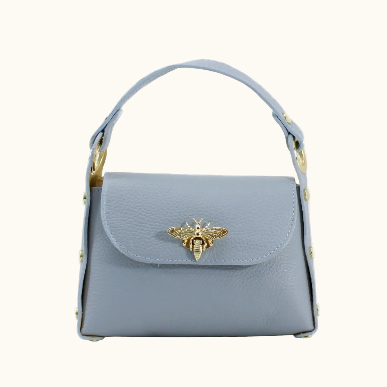 Light blue handbag with a gold bee emblem on a white background