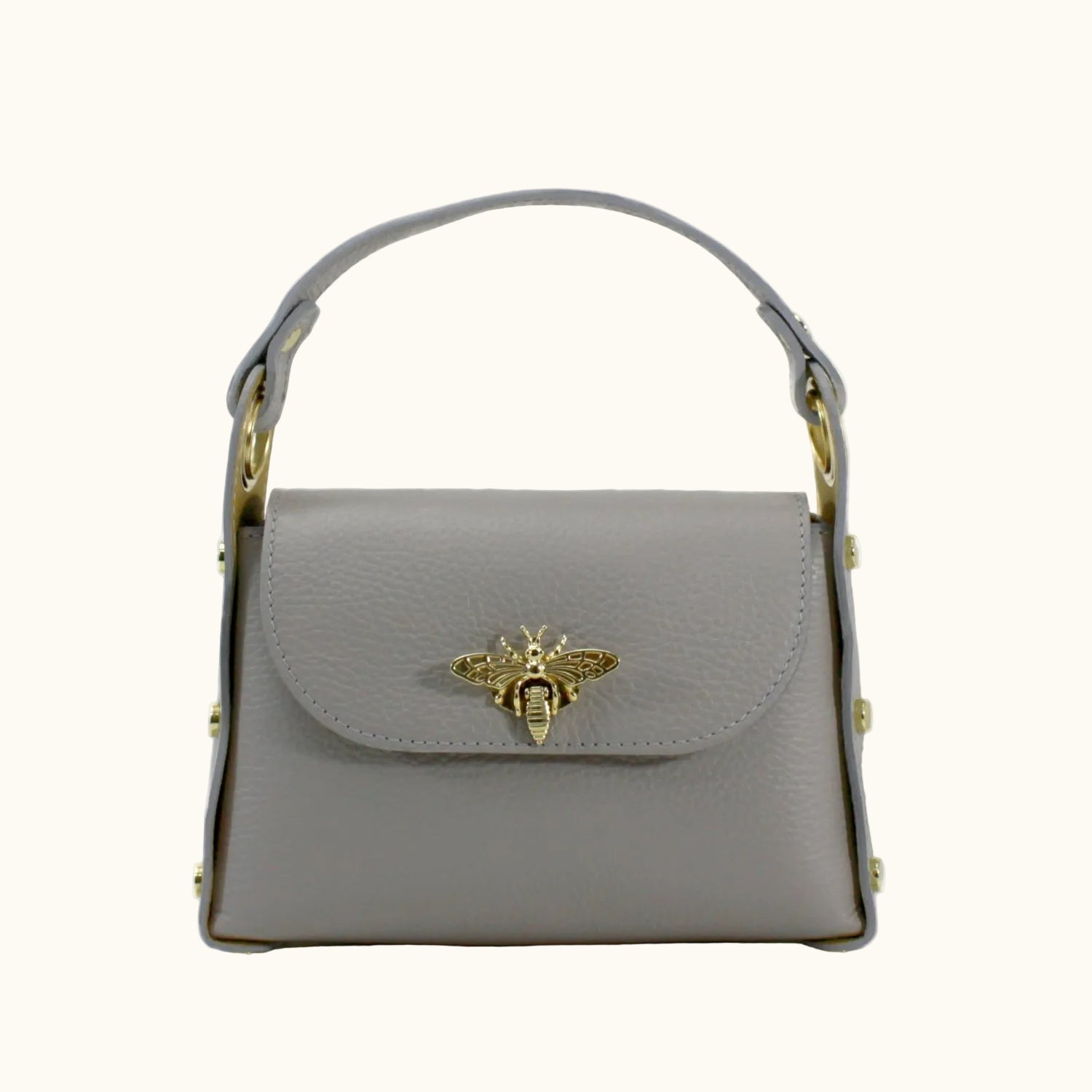 Gray handbag with a gold bee emblem on a white background