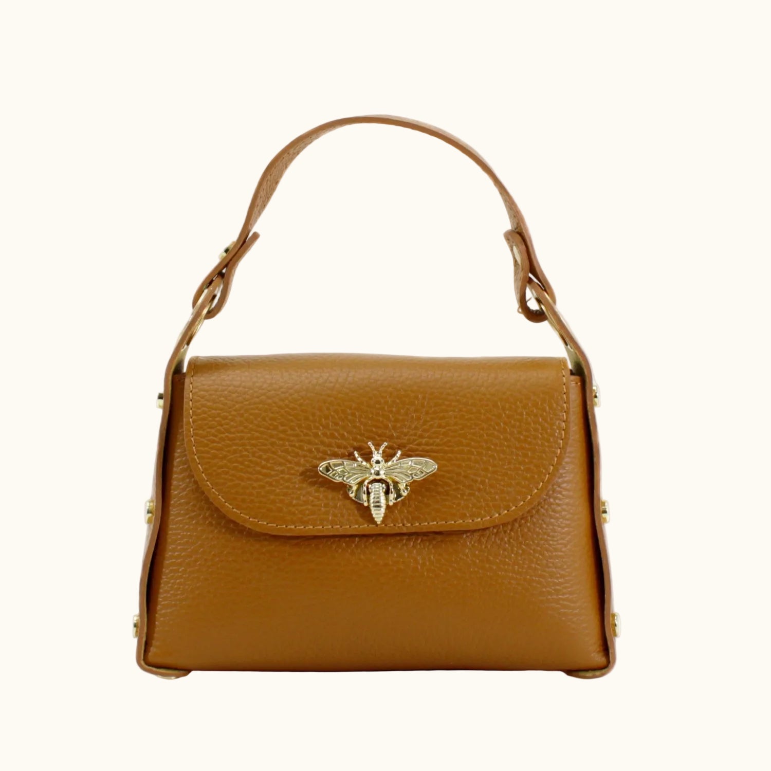 Brown leather handbag with a gold bee emblem on a white background