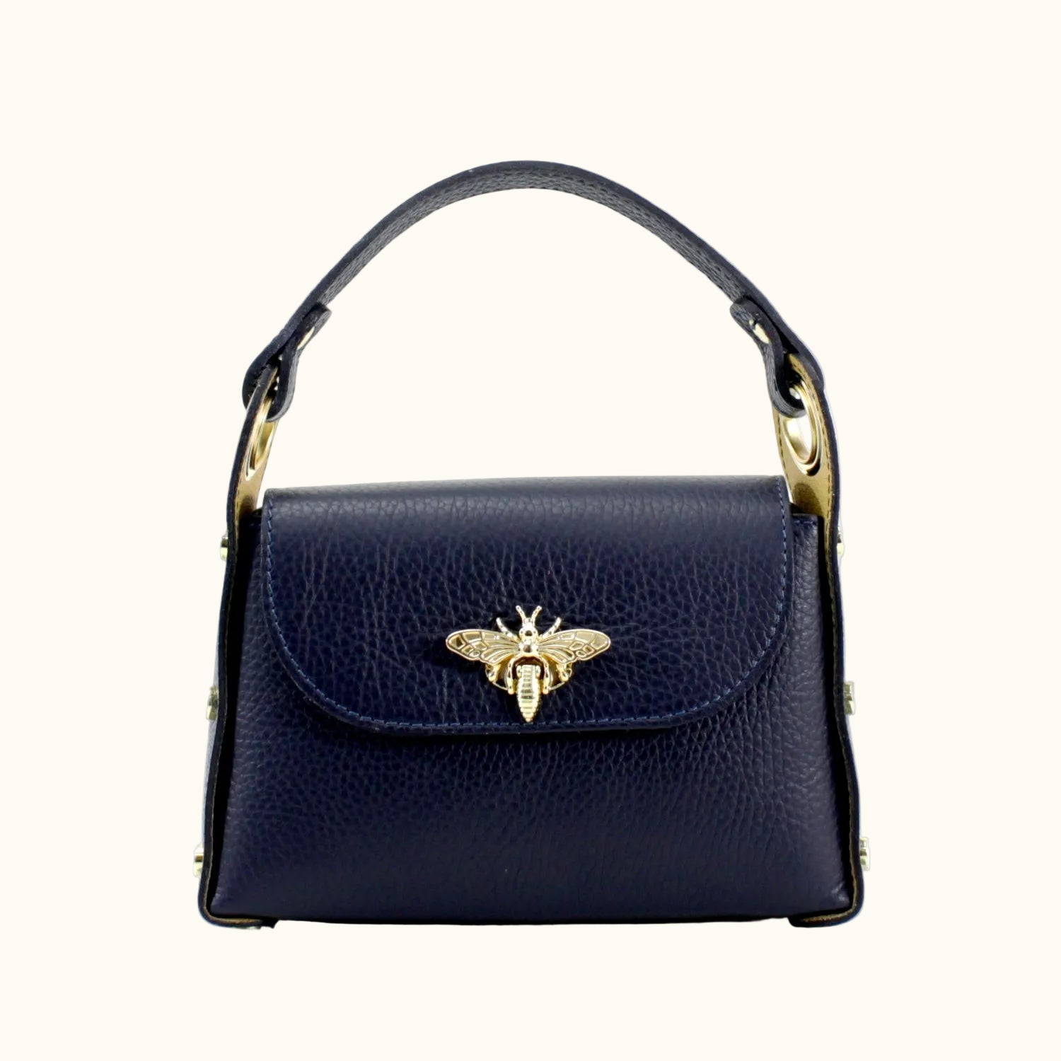 Navy blue handbag with gold bee emblem on a white background