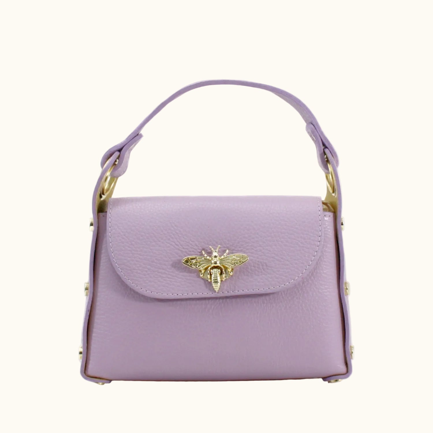 Purple handbag with a gold bee emblem on a white background