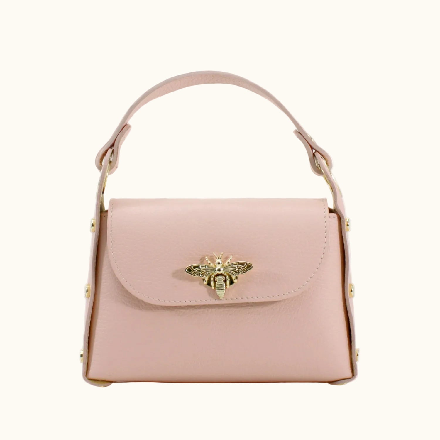 Pink handbag with a gold bee emblem on a white background