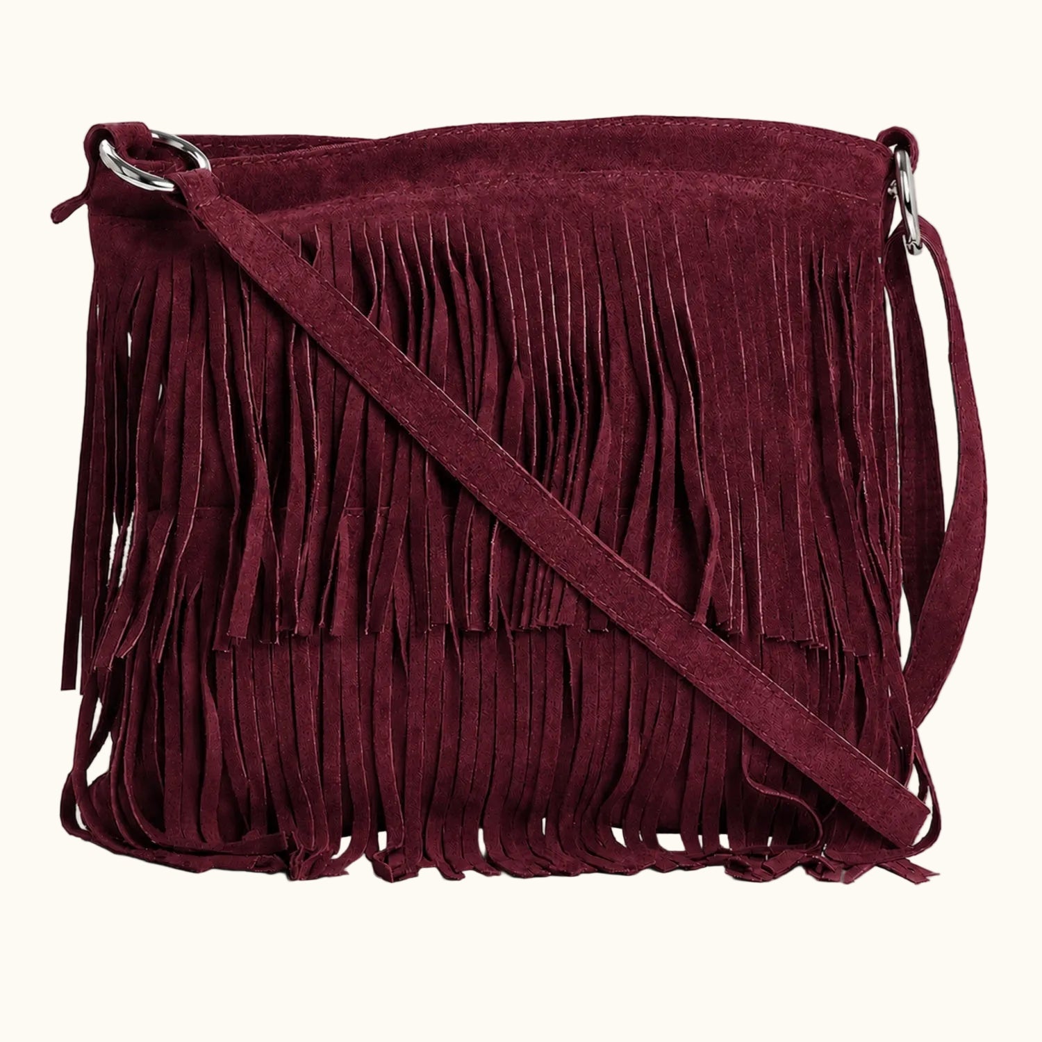 Maroon suede handbag with fringe details on a white background