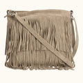 Beige suede handbag with fringe details on a white background