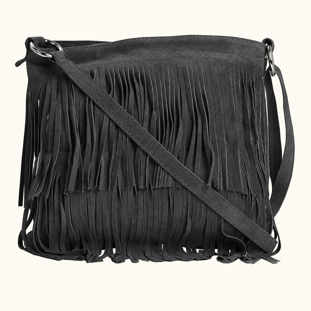 Black suede handbag with fringe details on a white background
